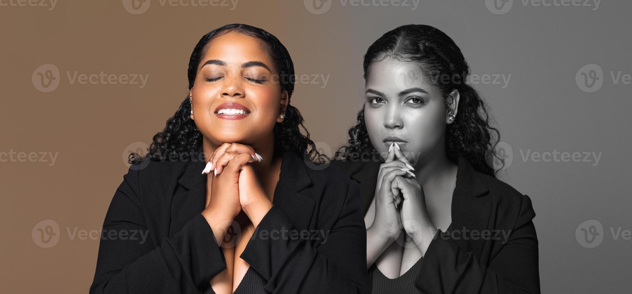 The young woman demonstrates her confidence while posing with a serene expression, hands clasped in front of her. She appears to be engaged in a reflective moment photo