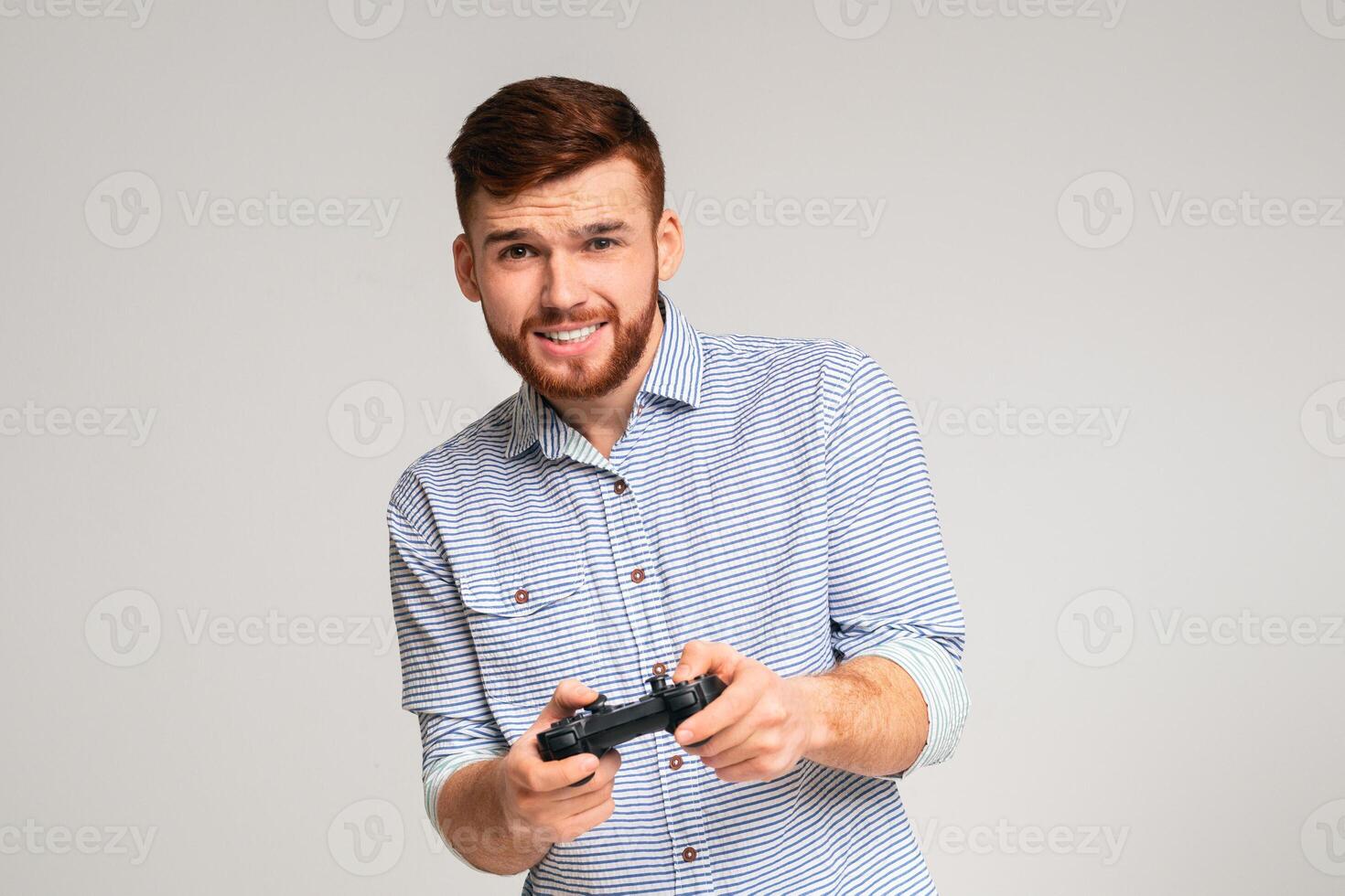 Gambling addiction. Young guy holding joystick and playing games on studio background, copy space photo
