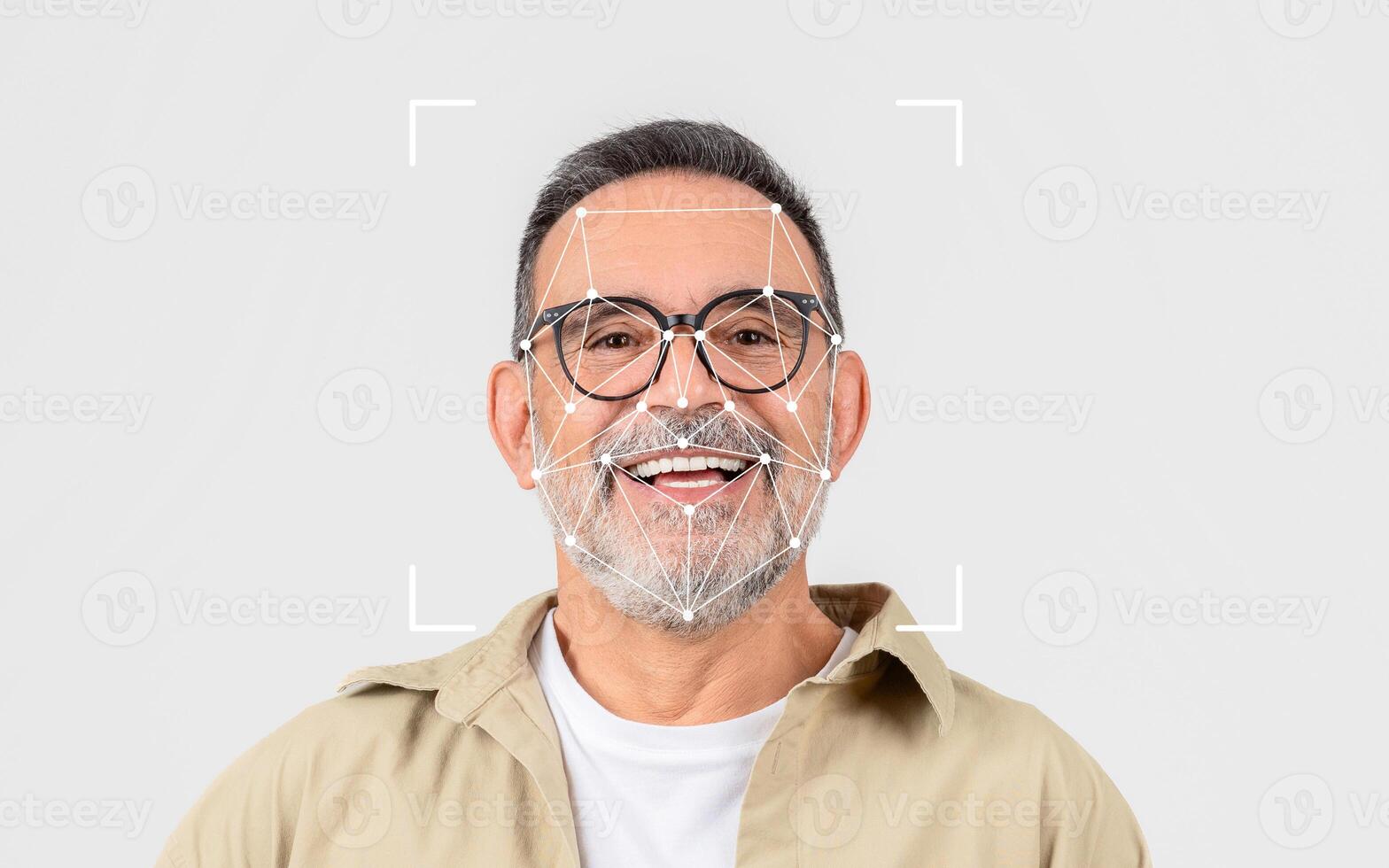 A smiling older man wears glasses, with a facial recognition grid overlay, set against a simple light background. photo