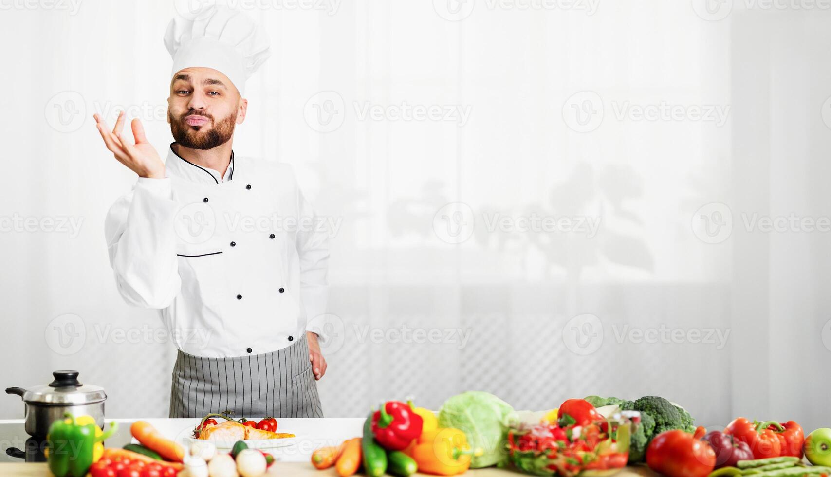 Great Recipe. Happy Chef Man Gesturing Approving Taste Looking At Camera Standing In Restaurant Kitchen. Selective Focus photo
