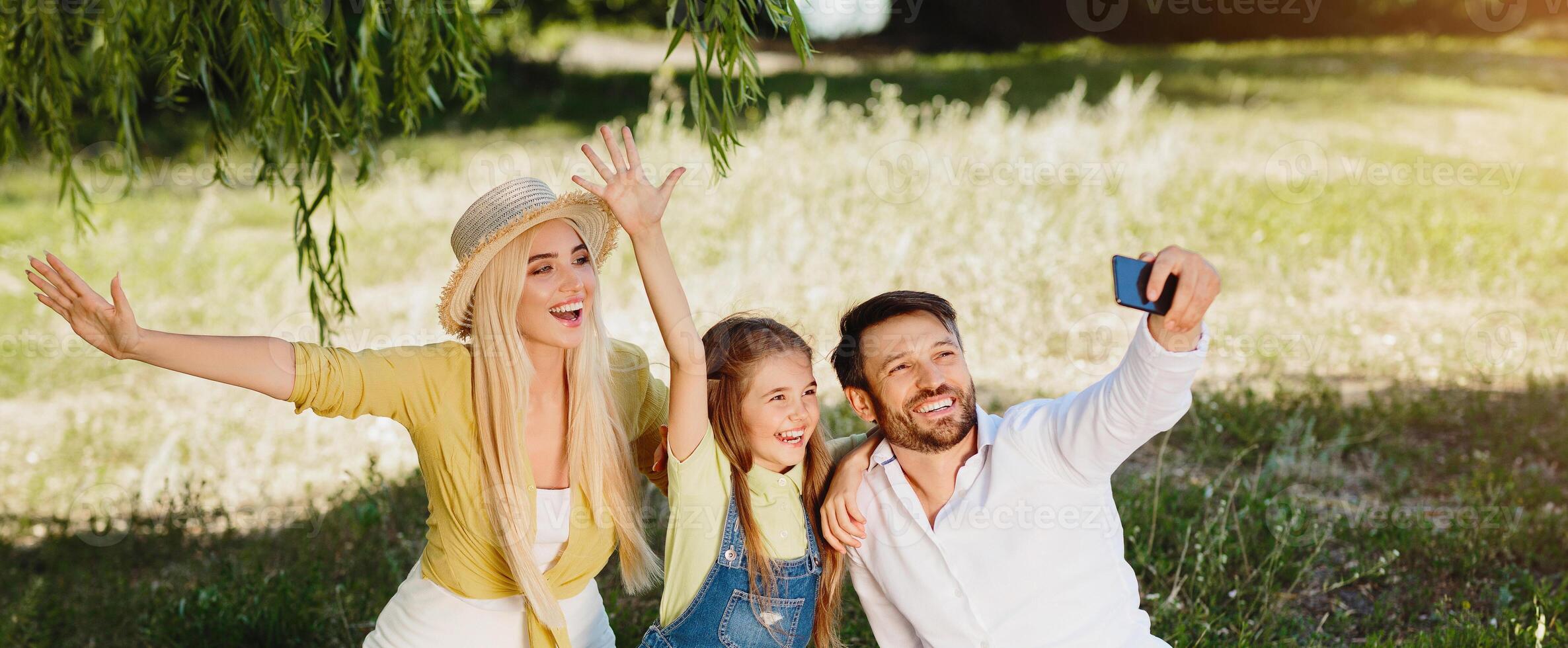 Summer Fun. Happy Family On Picnic Making Selfie Spending Sunny Day Together In Nature Outdoor After Quarantine And Parks Reopening. photo