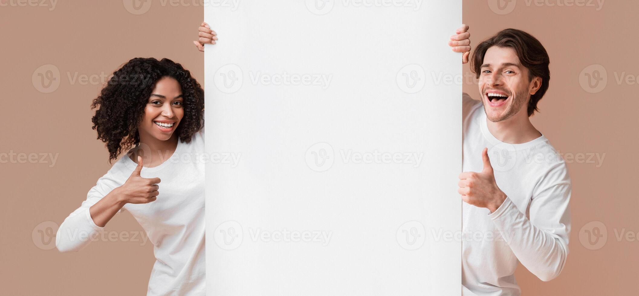Happy Interracial Couple Holding White Advertising Board And Showing Thumbs Up, Recommending Something Over Yellow Studio Background, Free Space photo