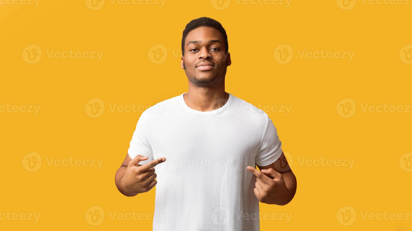 You Found Right Guy, Pick Me. Self-assured black man promoting himself, pointing at body over orange background photo