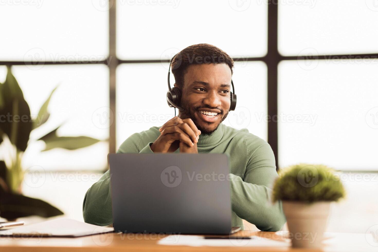 Friendly Operator. Smiling frican american salesman consulting client looking aside, free space photo