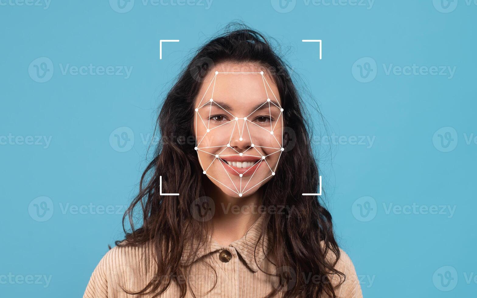 A woman is smiling while facial recognition dots are mapped on her face against a bright blue background. photo
