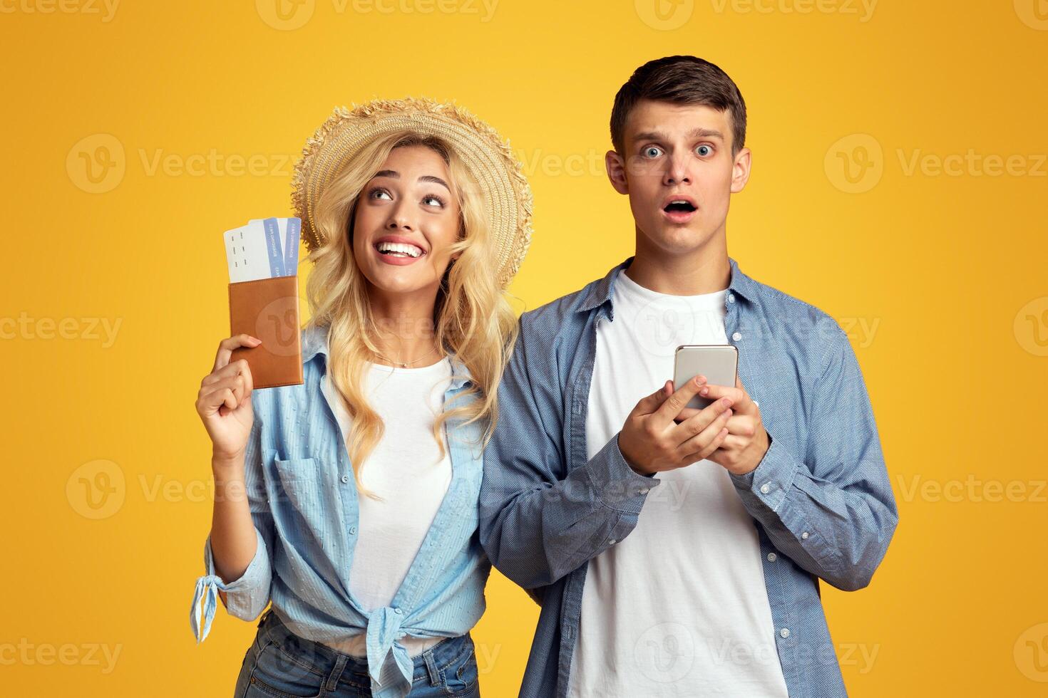 Vacation cancelled. Shocked guy with smartphone receiving message that their visa rejected, while his girlfriend still dreaming about trip. photo