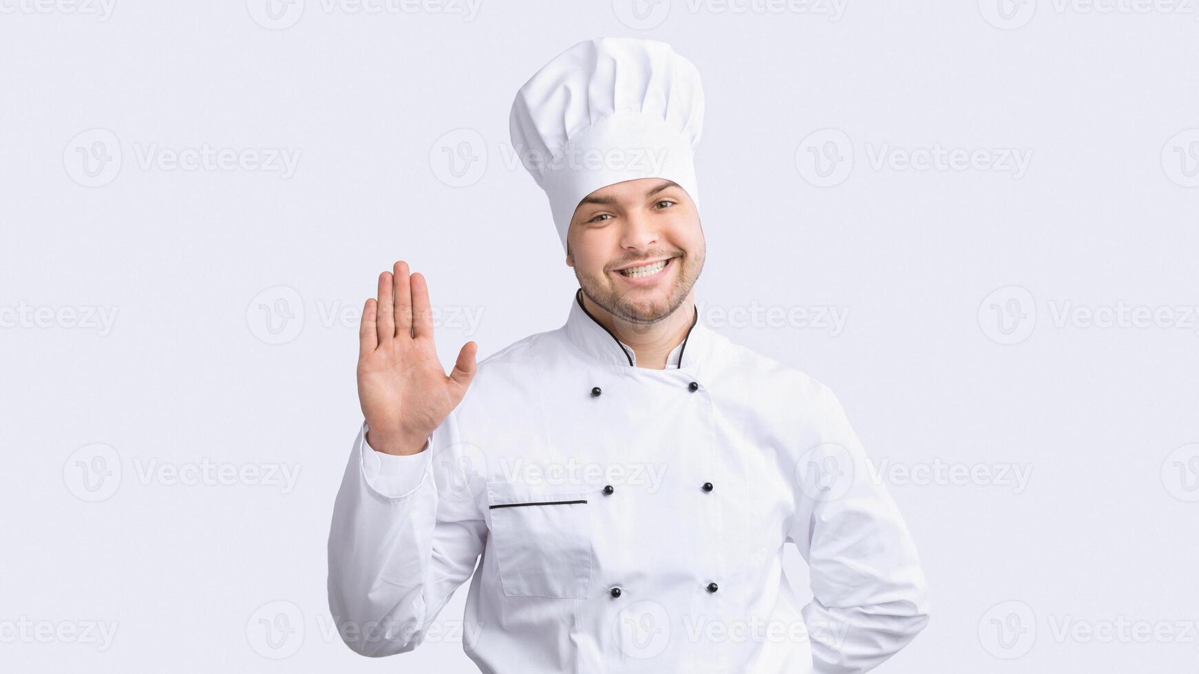 Hello, I'm Chef. Professional Cook Man Waving Hand Smiling To Camera Standing Over White Studio Background. Panorama photo
