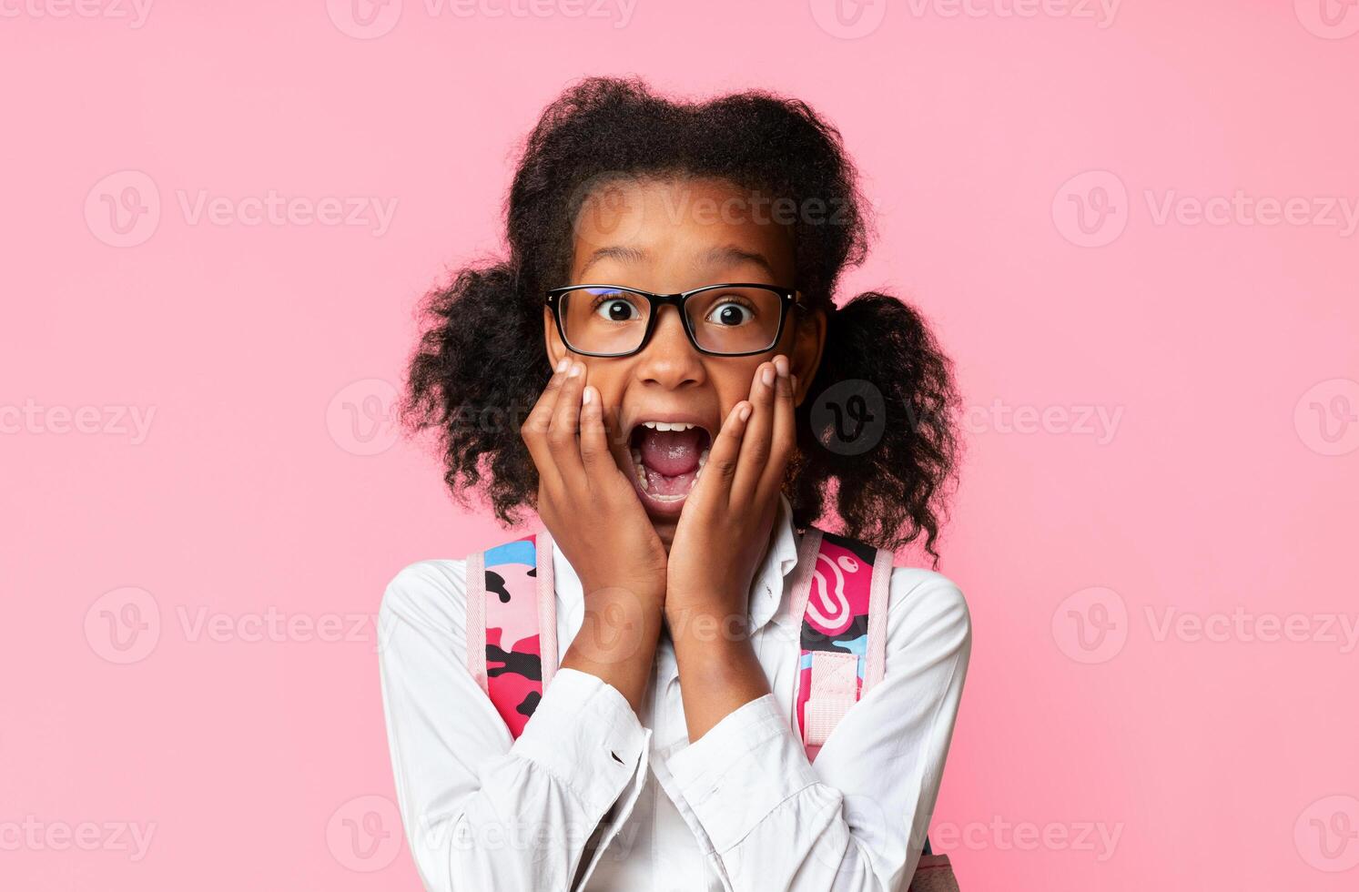 Back-To-School After Quarantine. Shocked Girl With Backpack Shouting Looking At Camera Touching Face Posing Over Yellow Background. Studio Shot photo