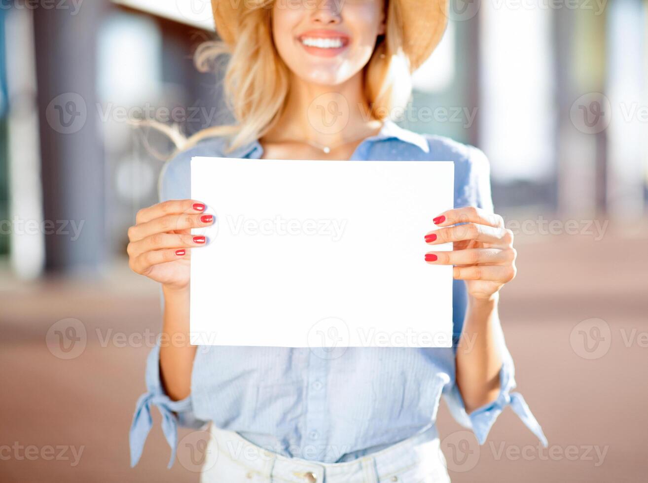 Pretty woman holding empty placard outside the airport, copy space for text photo