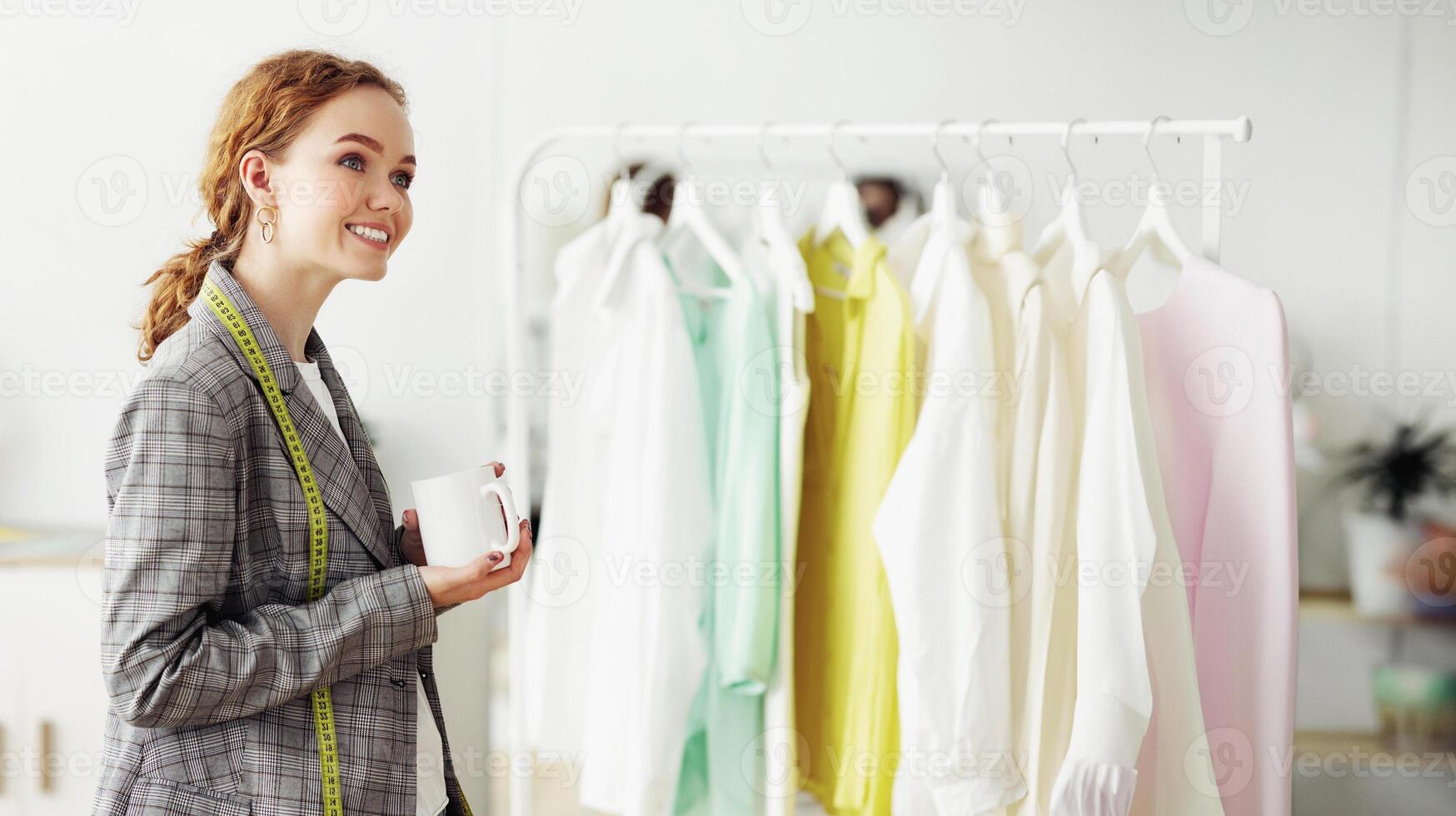 Running fashion business. Couturier girl drinking coffee in her own dressmaking studio, free space photo