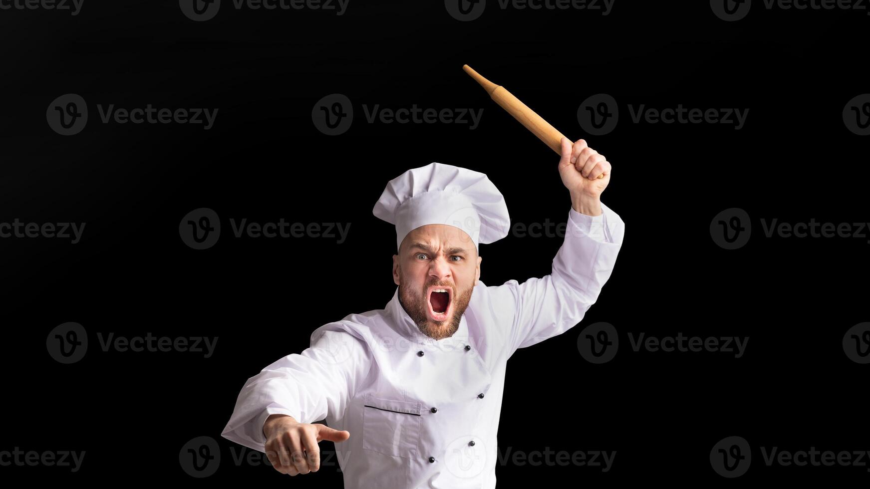 Angry Chef Bakerman Raising Rolling Pin Threateningly Posing Over Black Background. Studio Shot photo