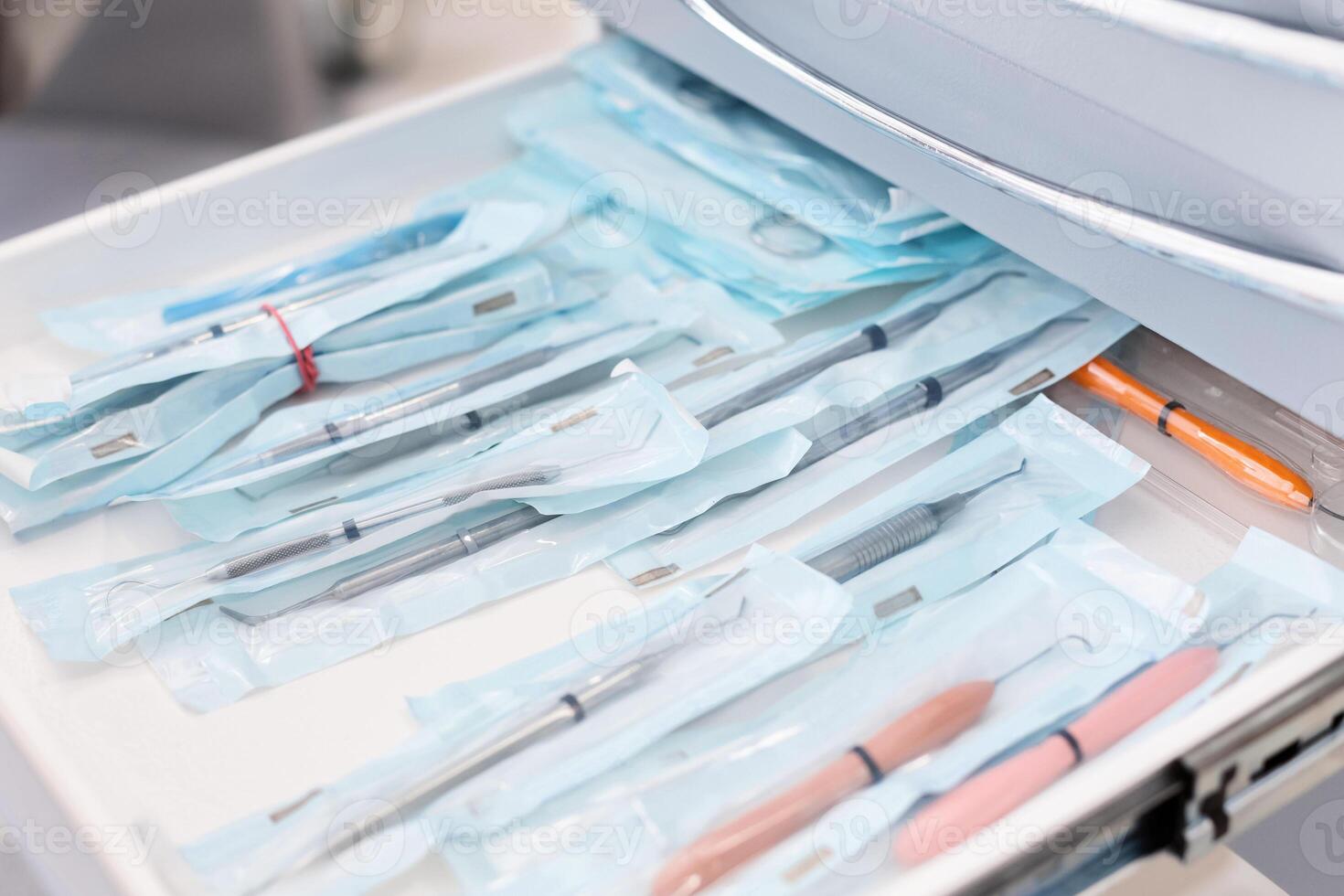 Close up of sealed dentist tools in open drawer, dental equipment concept photo