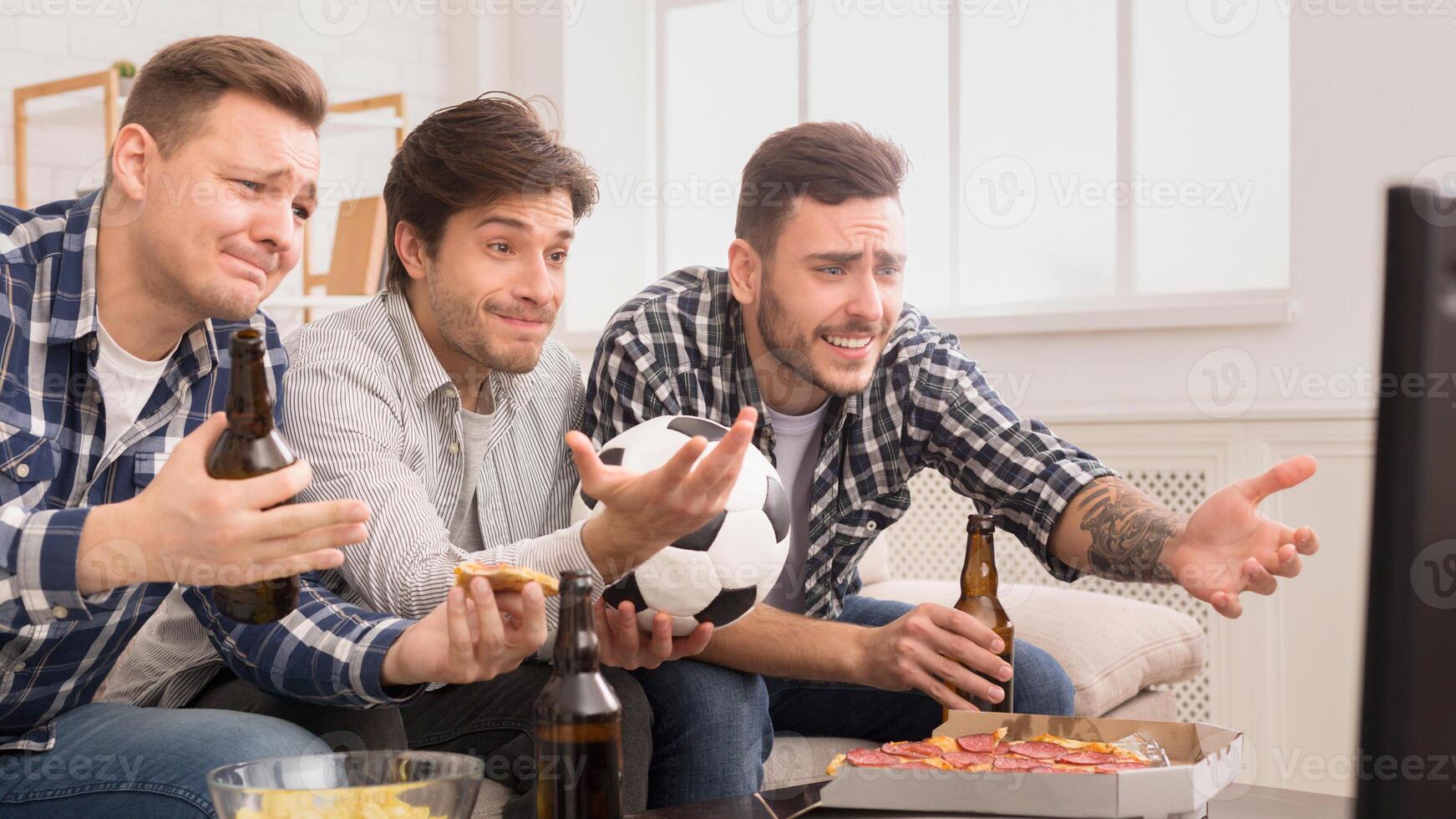 A trio of european men debate a moment in a soccer game, capturing their passionate friendship as mates photo