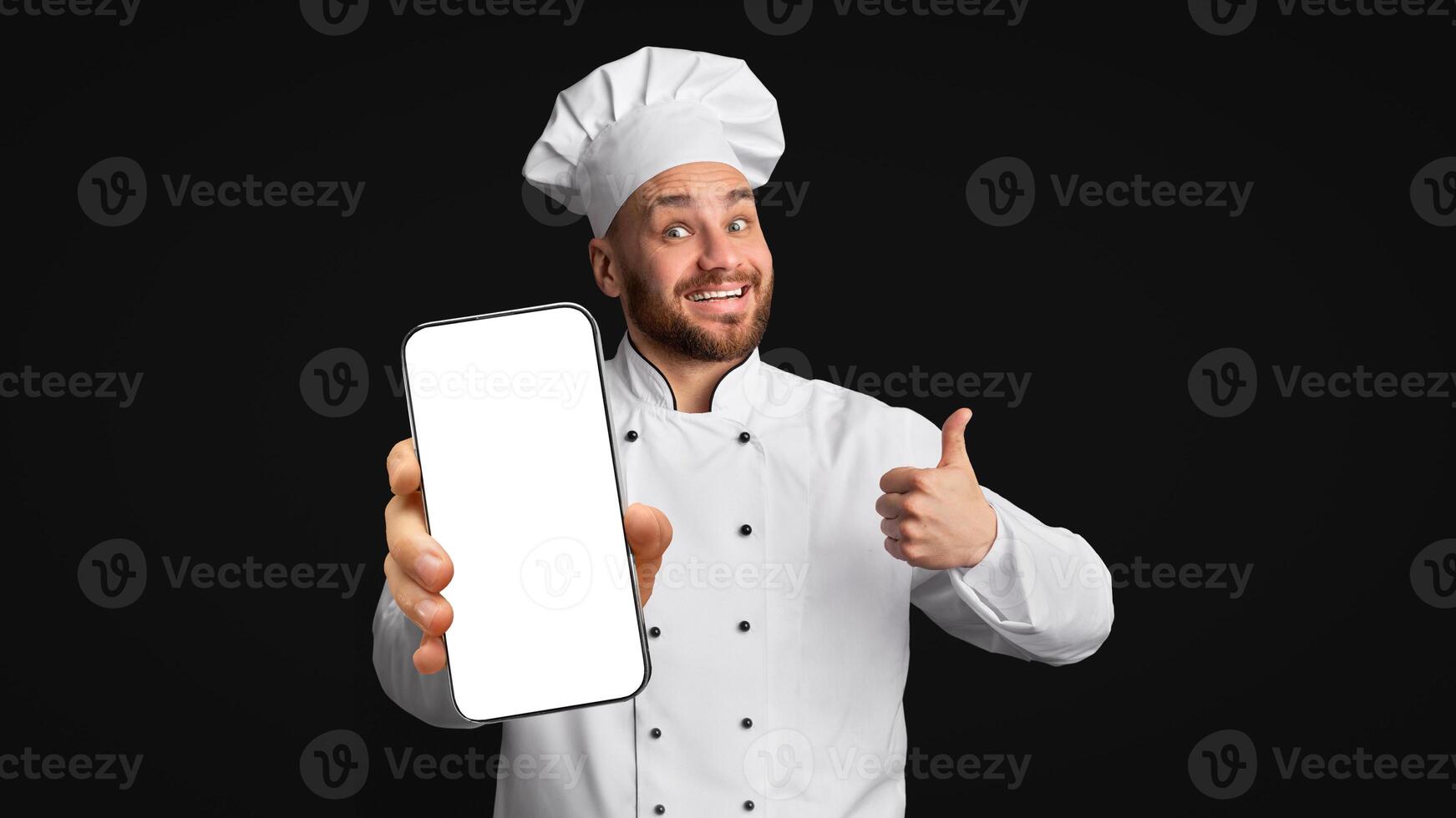 Smiling Cook Man Showing Tablet Empty Screen Gesturing Thumbs Up Posing Over Black Studio Background. Panorama, Mockup photo