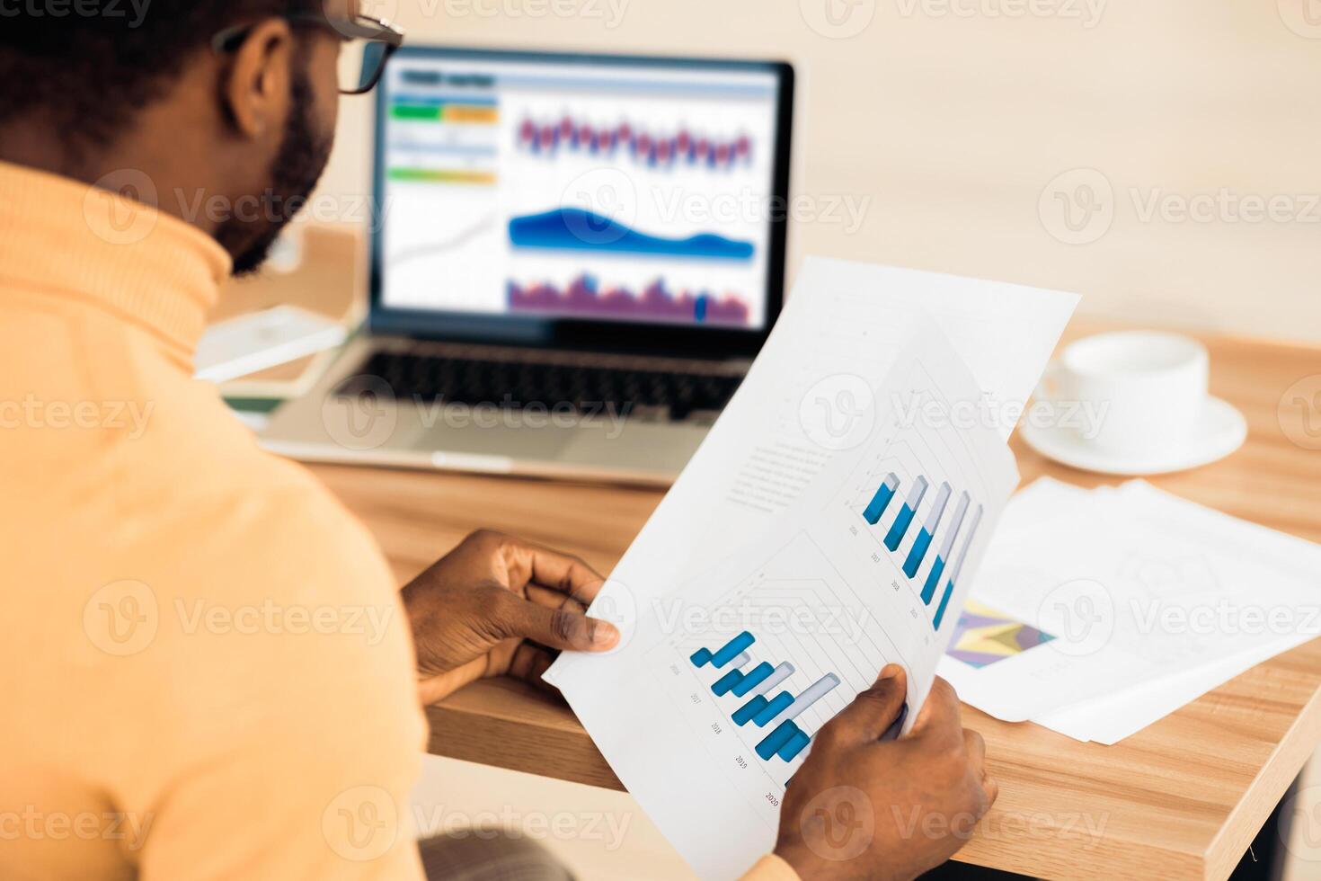 Busy Day. Rear view of afro trader working with charts and market reports on computer screen in office, free space photo