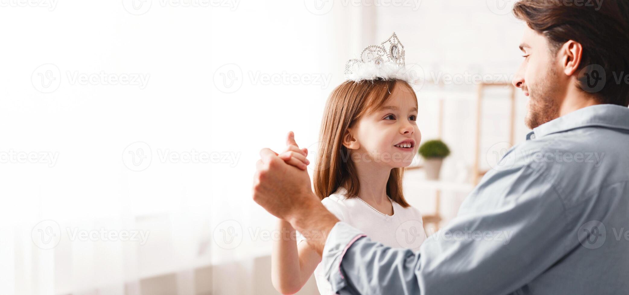 Close up of handsome dad dancing with his daughter indoor, happy to be father photo
