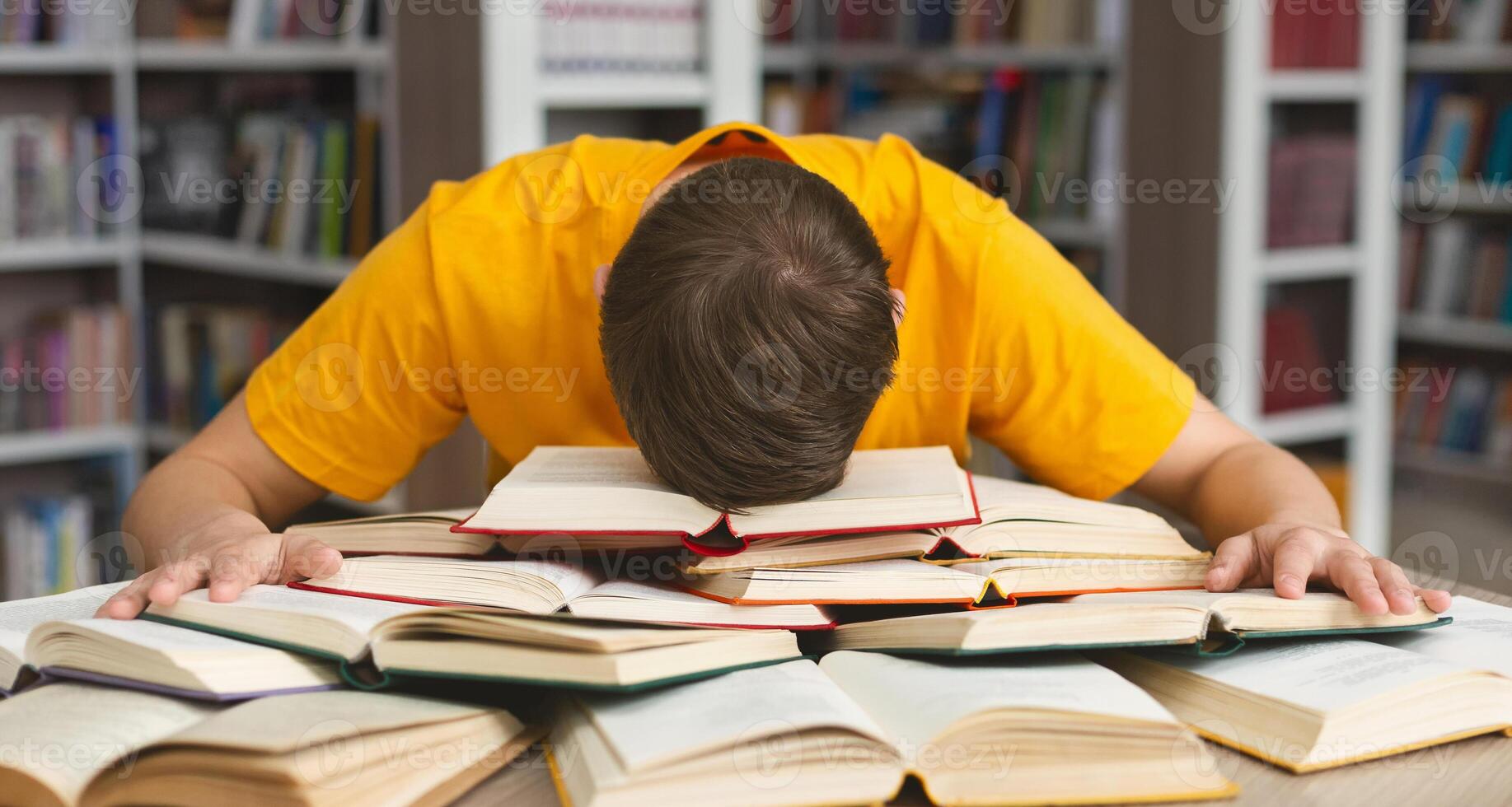 Student studying hard exam and sleeping on books in library, free space photo