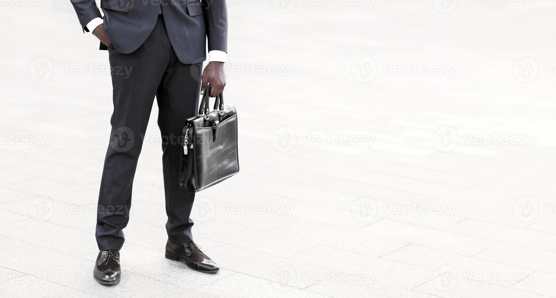 Business Career Concept. Unrecognizable Black Businessman Standing Holding Briefcase In City Outdoors. Copy Space, Cropped photo