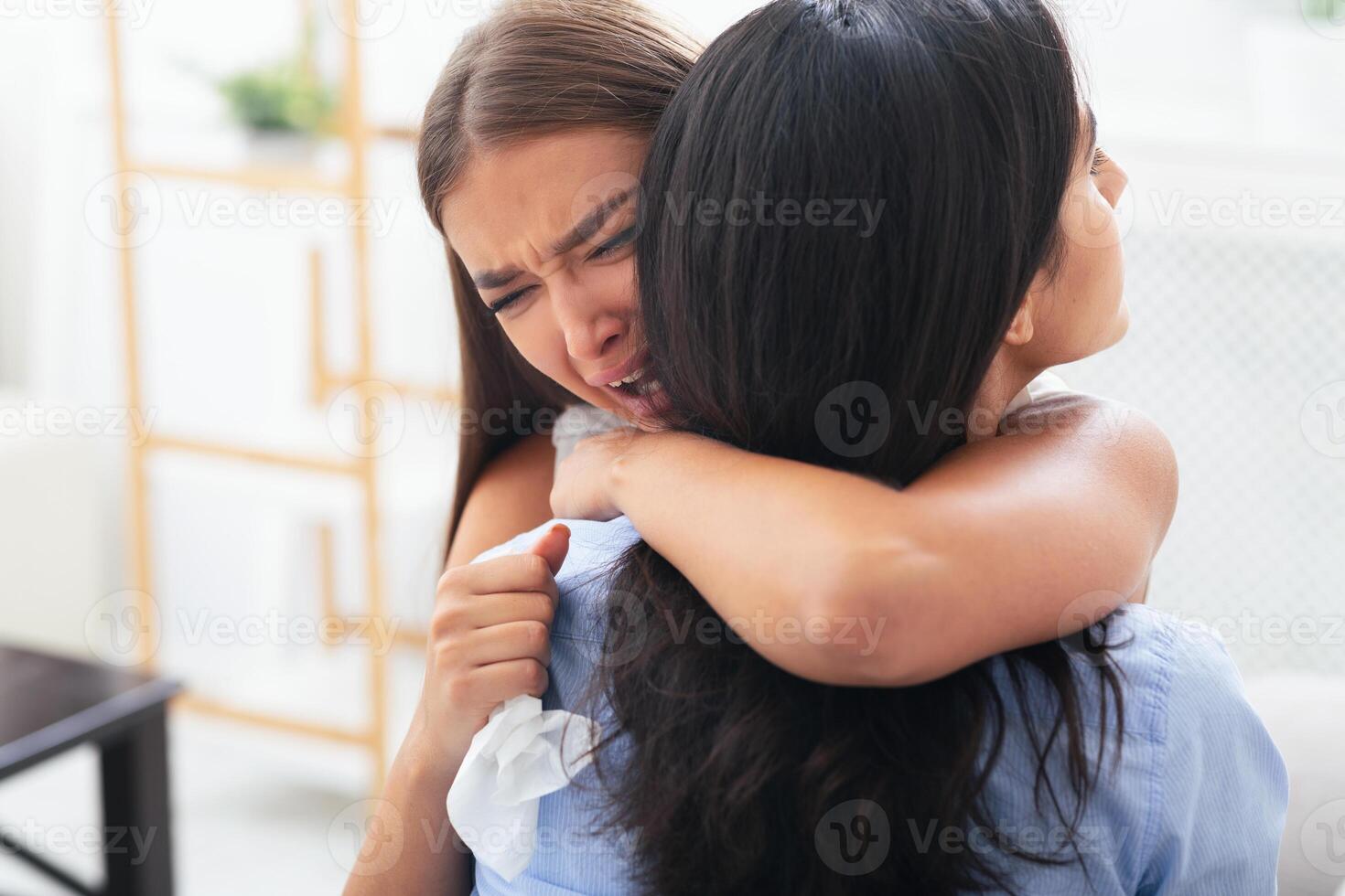 Depression. Unhappy Girl Crying On Friend's Shoulder Complaining About Problems Indoor. Selective Focus photo
