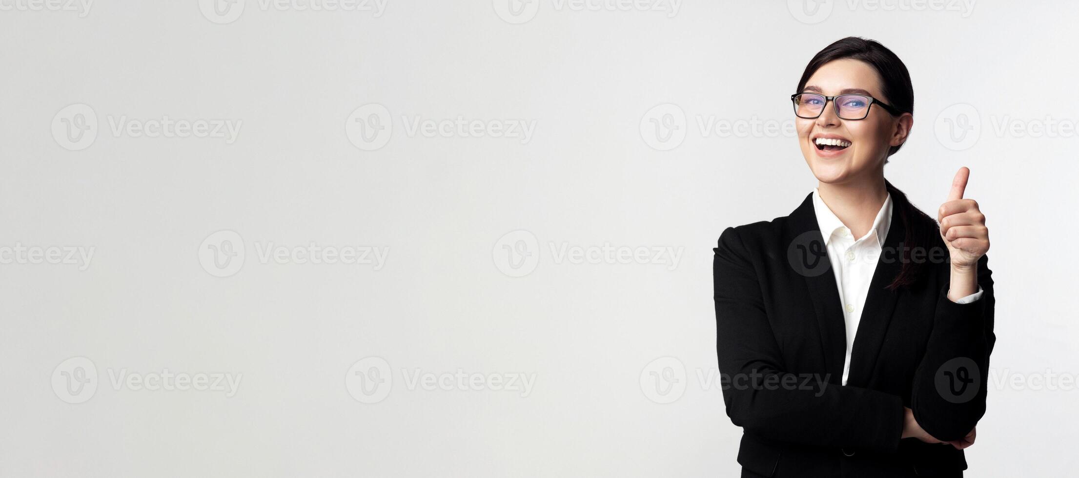 Like. Happy Business Girl Gesturing Thumbs-Up Standing On White Studio Background. photo