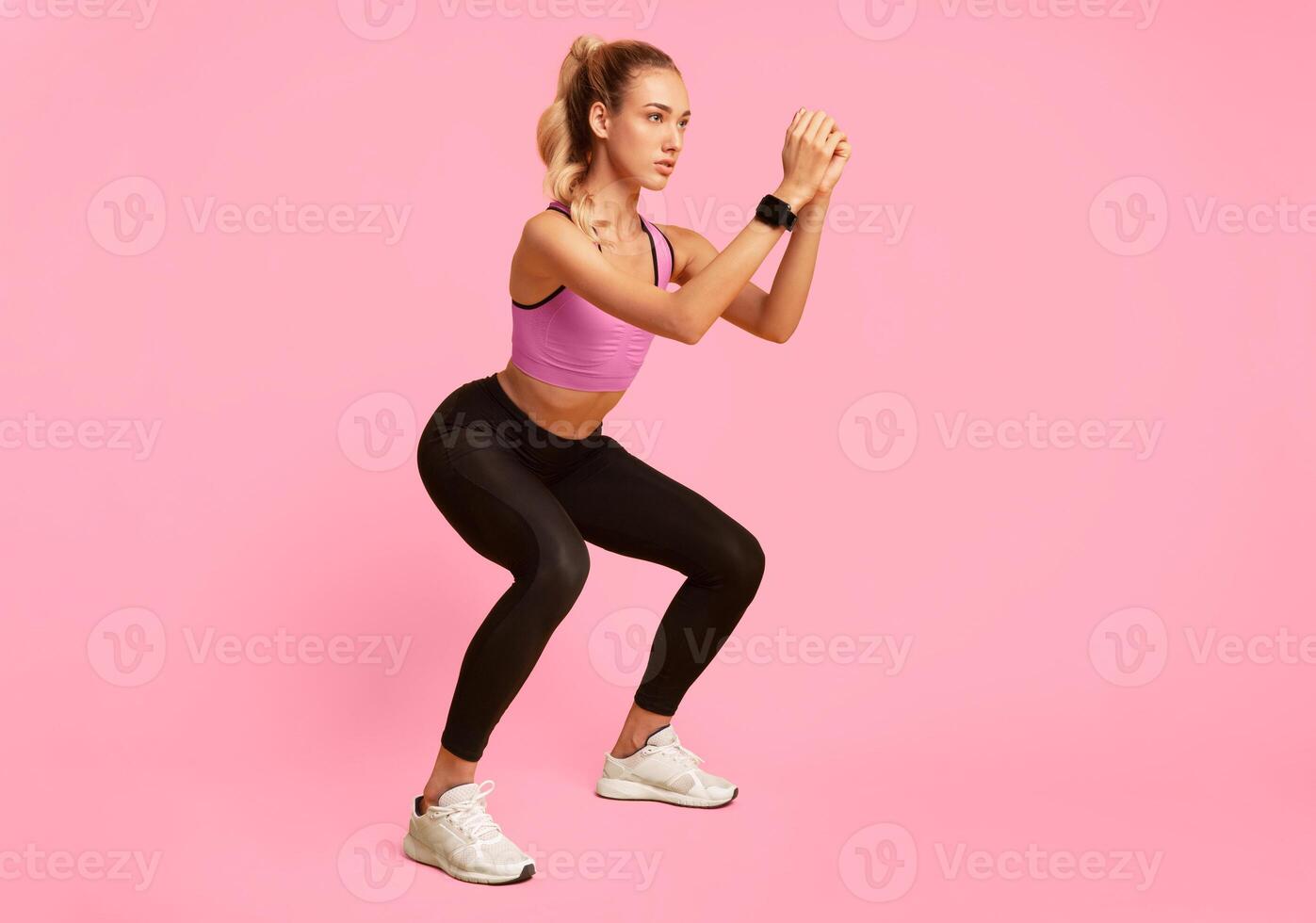 Workout. Young Woman Doing Deep Squat Exercise Over Yellow Studio Background. Copy Space photo