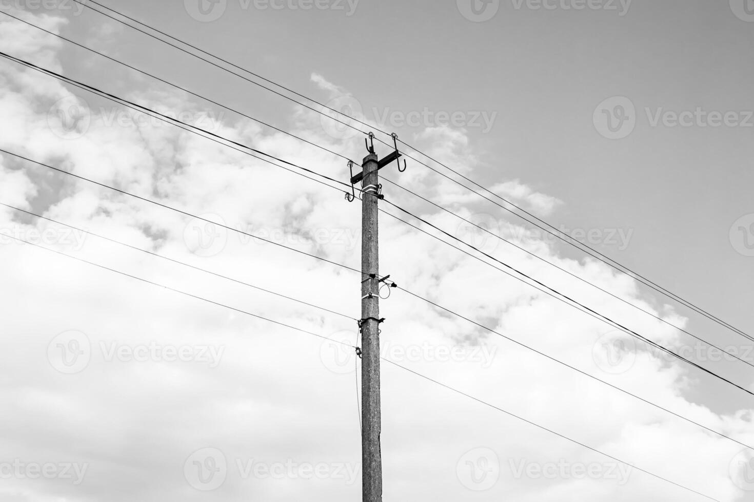 Power electric pole with line wire on dark background close up photo