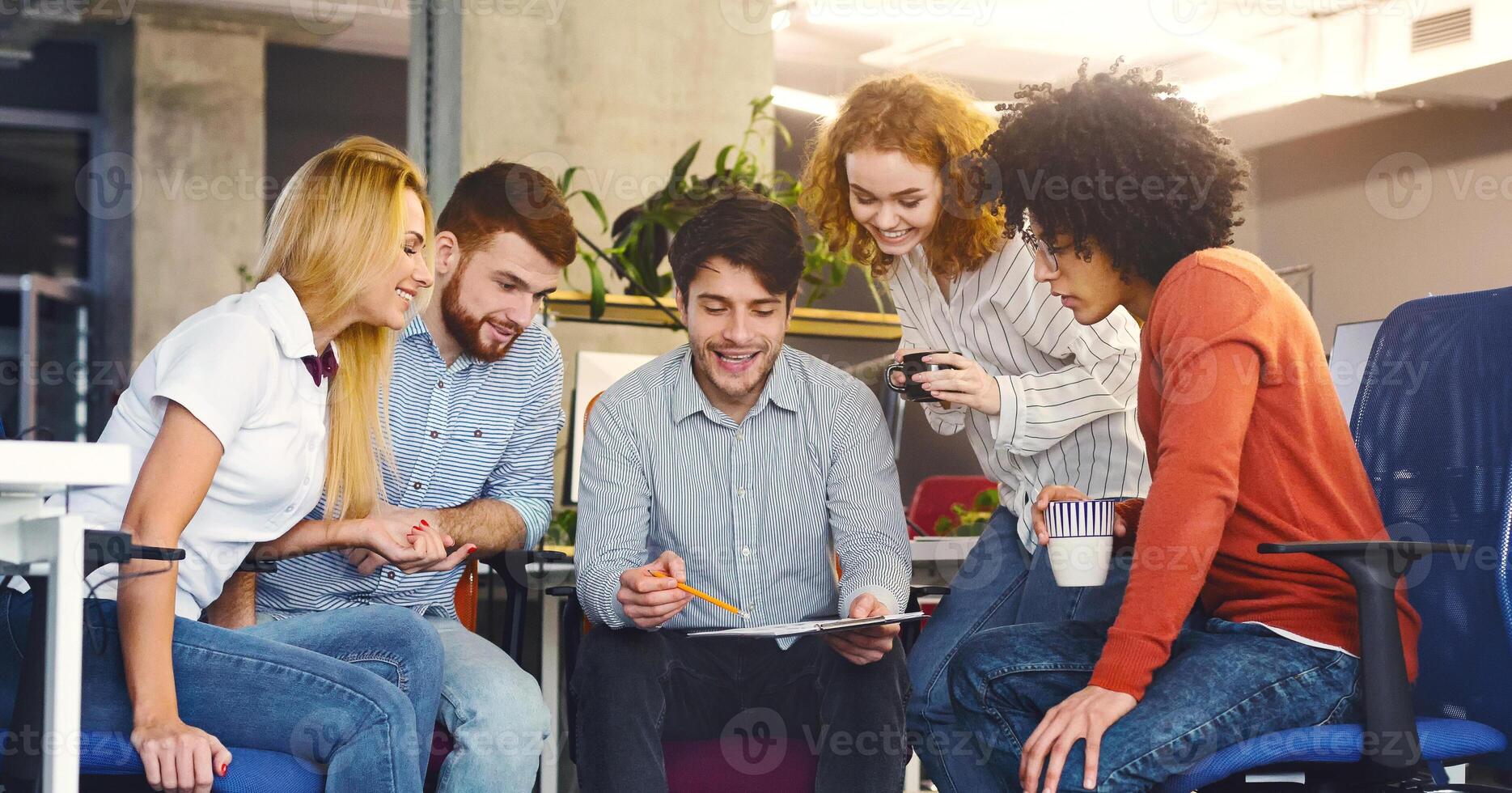 Informal meeting. Group of young coworkers discussing new marketing strategy in office, panorama photo