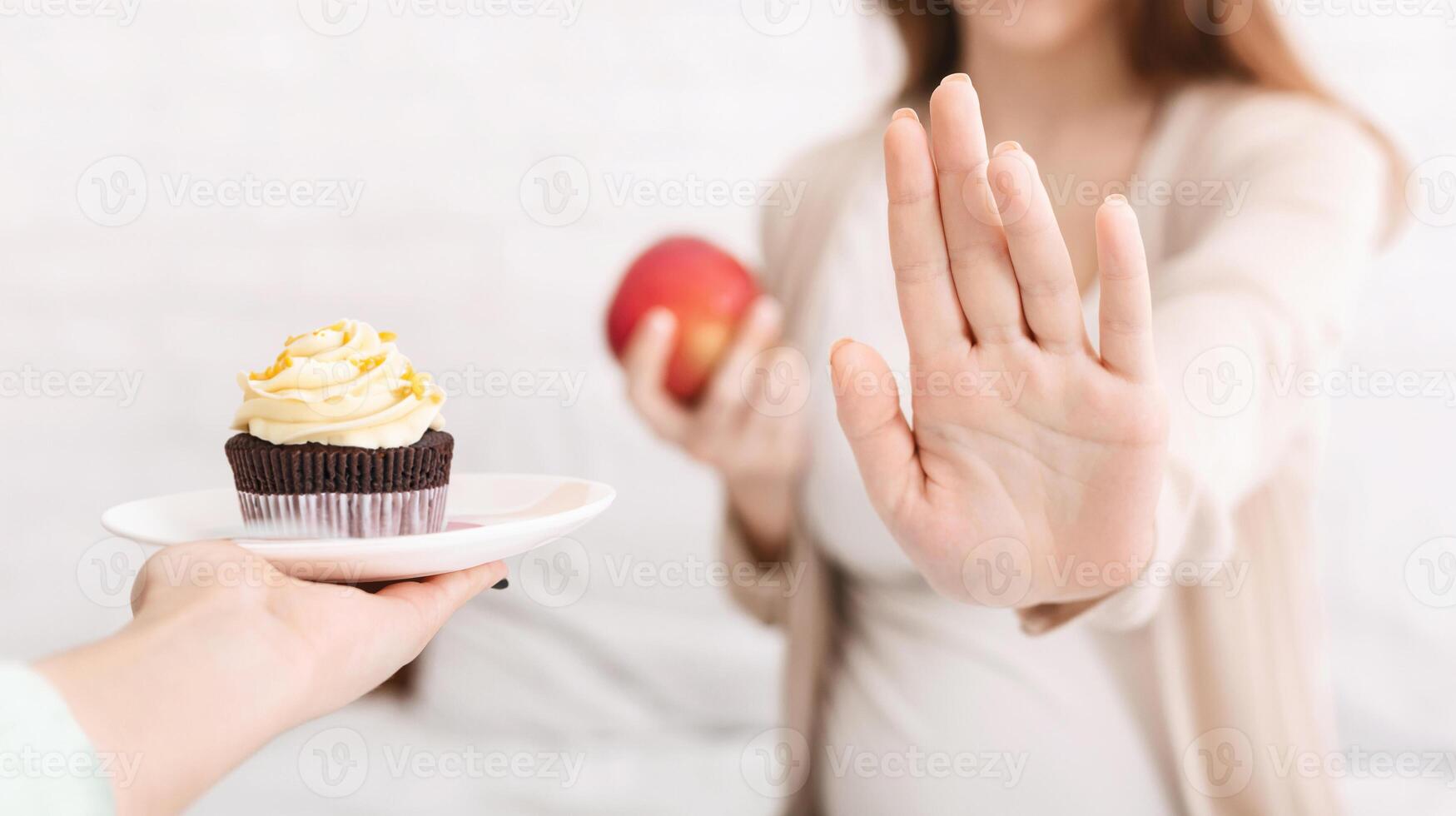 Dieting pregnancy. Pregnant woman refusing her favorite junk food such as croissant and choosing fresh apple instead, panorama photo