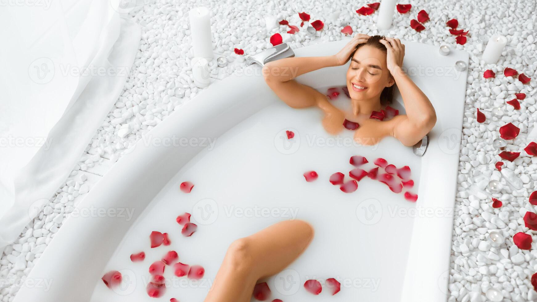Body skin care. Woman enjoying milk bath with rose petals, relaxing in spa, free space photo