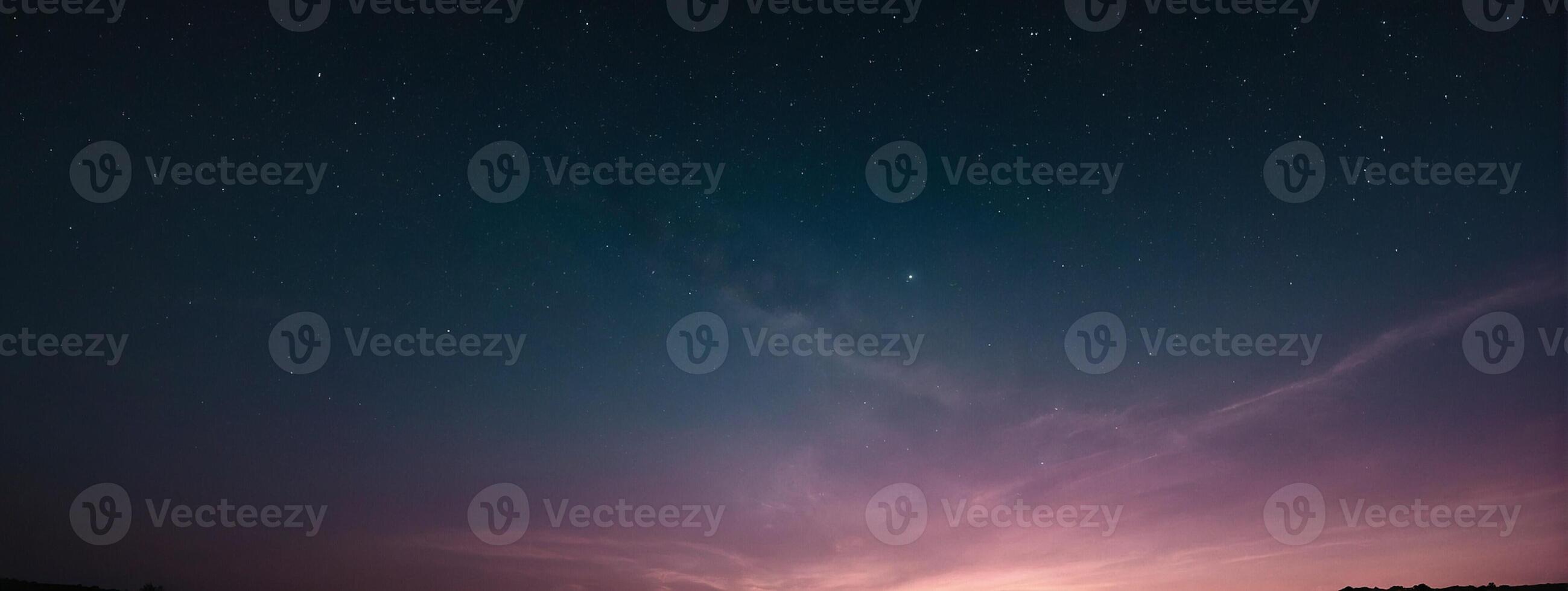 A purple sky with stars and clouds over a field photo
