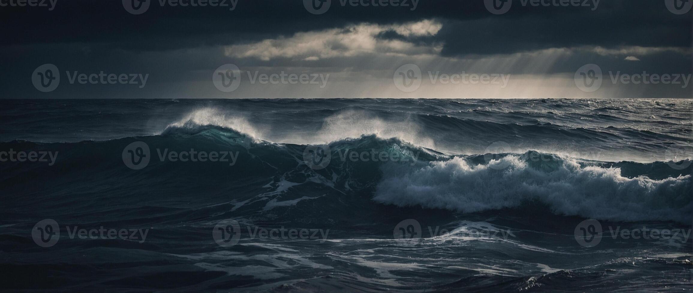 A dark stormy ocean with waves and sun rays photo