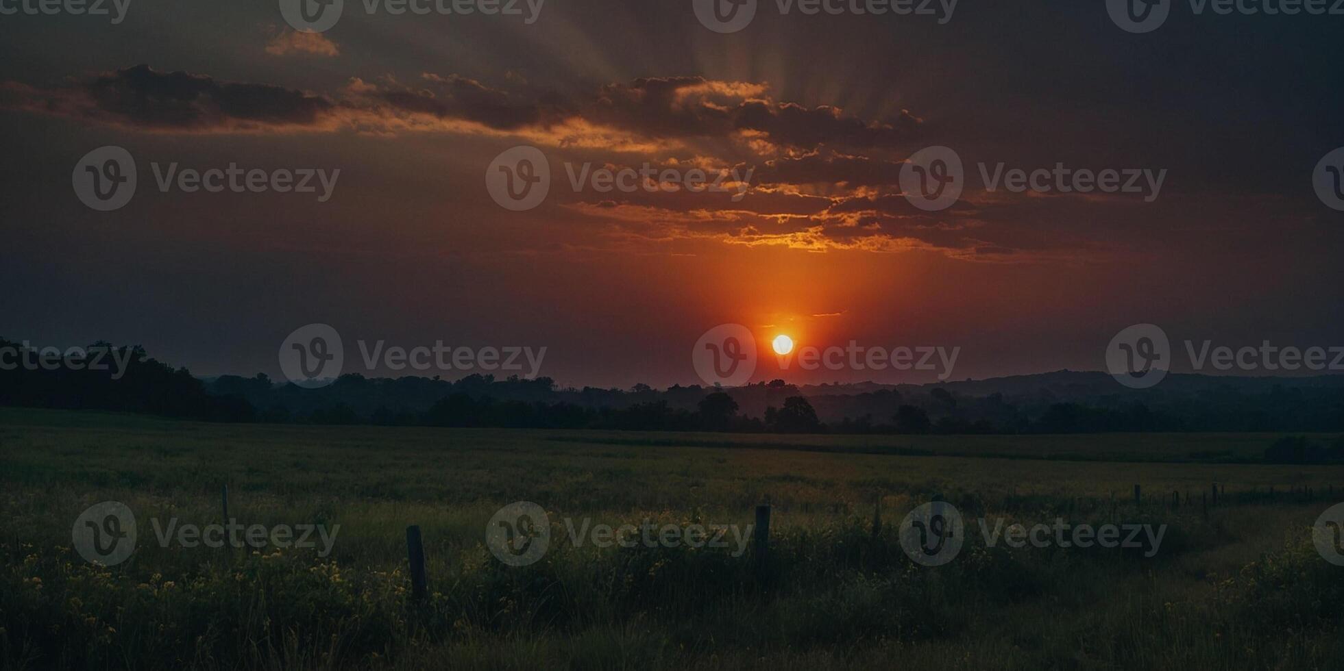 Sunset over a field with a fence and a fence photo