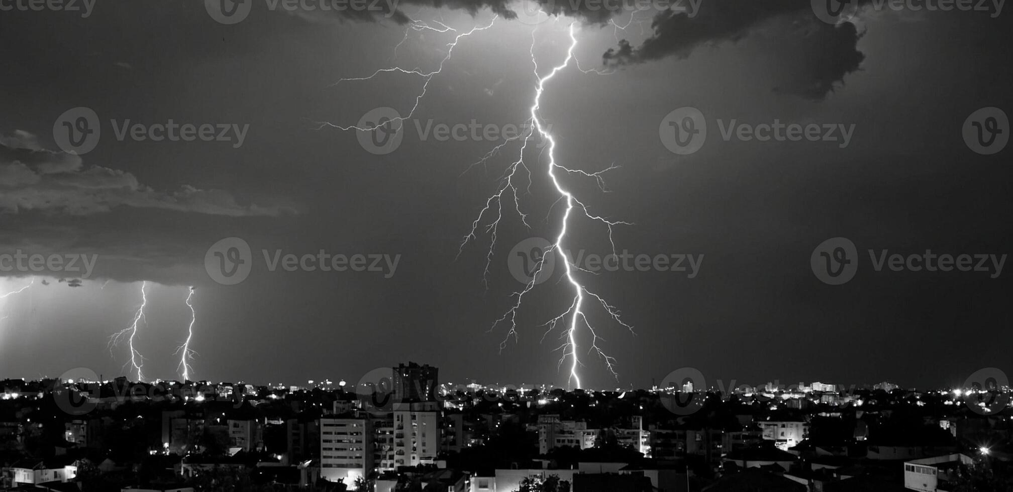 Black and white photo of lightning striking over a city
