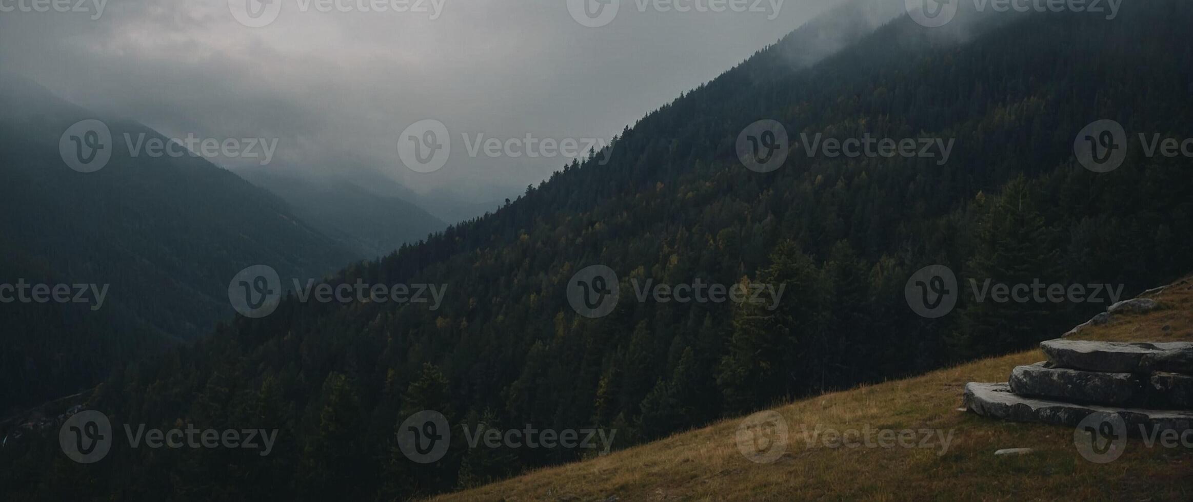 A person sitting on a bench in the middle of a mountain photo