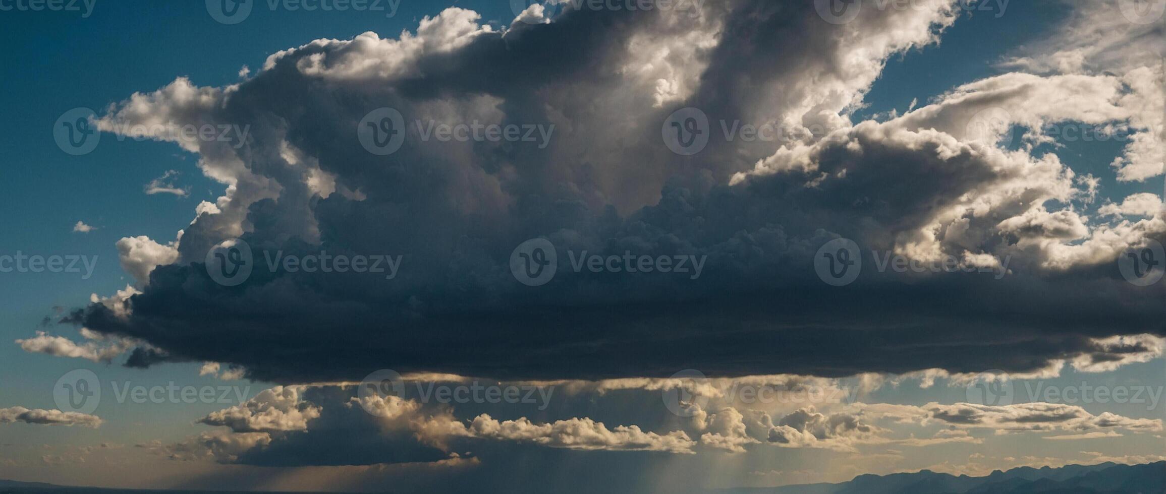 A large cloud is seen over the mountains photo