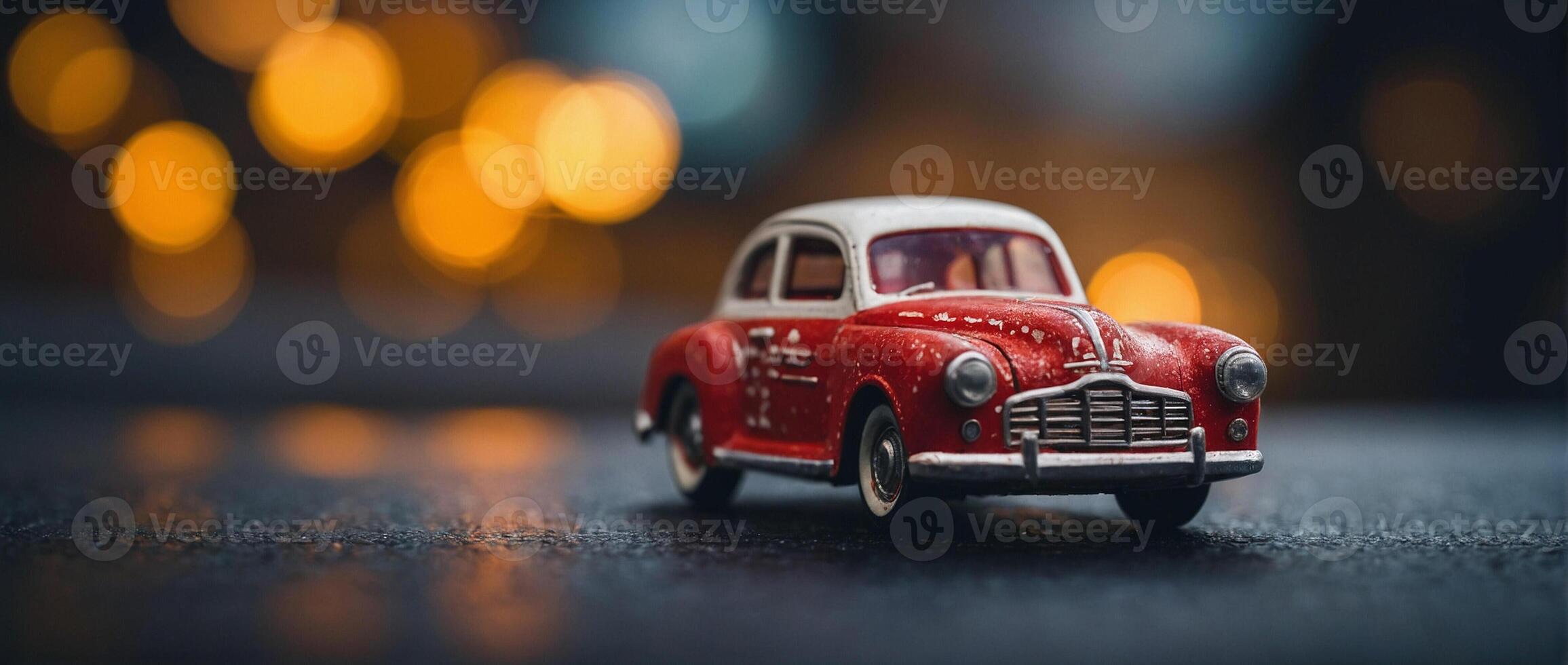A red toy car sitting on a table with blurred lights photo