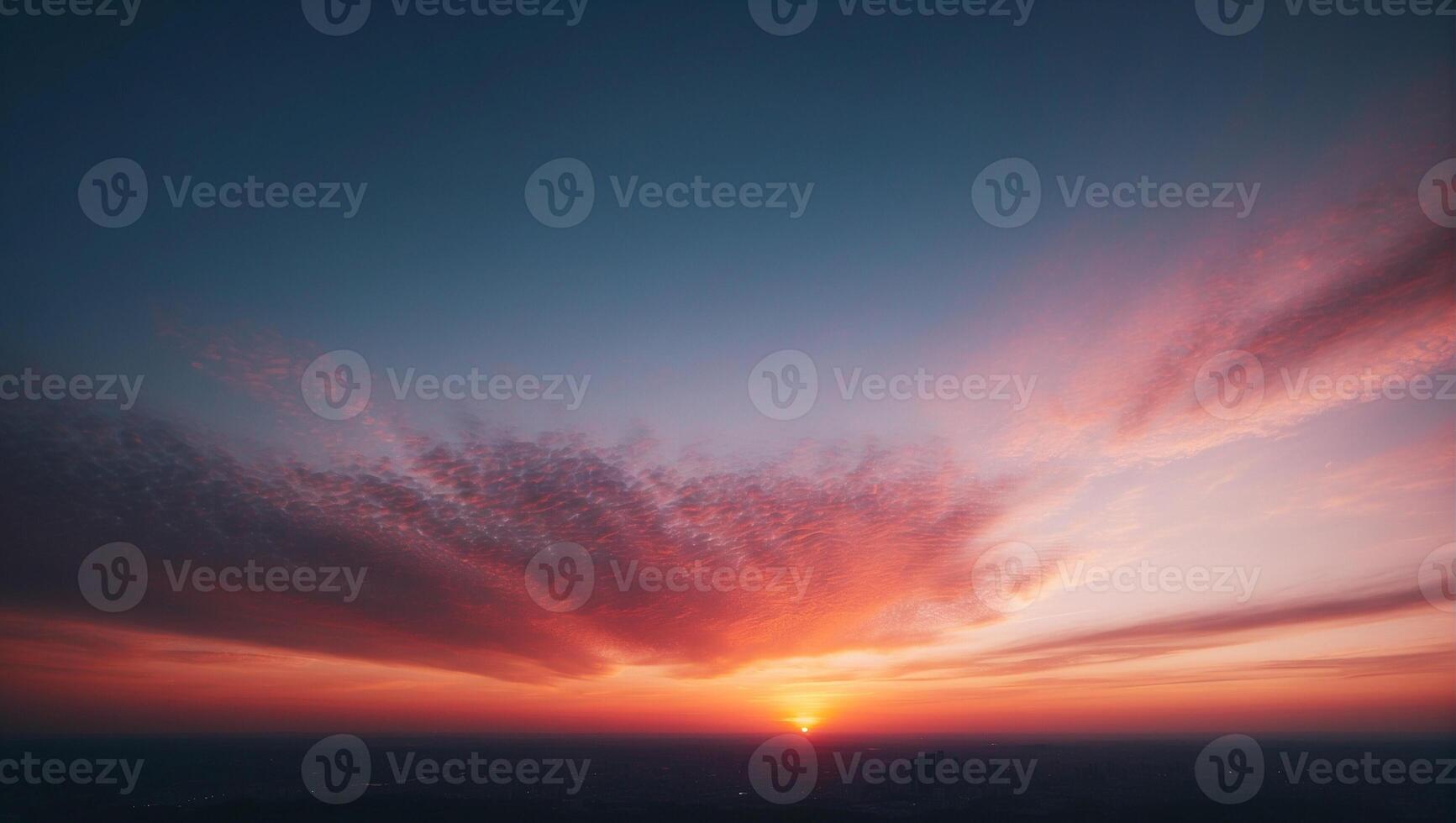 A sunset over a city with clouds in the sky photo