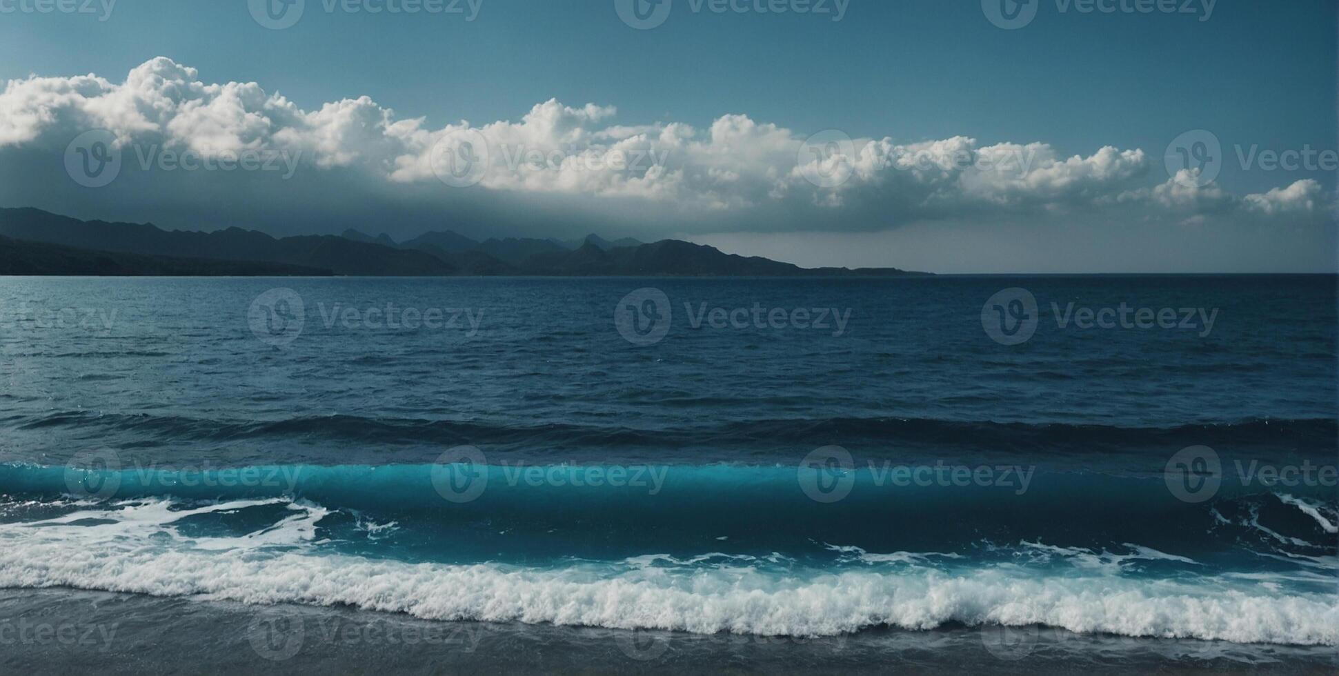 A blue ocean with waves and clouds photo
