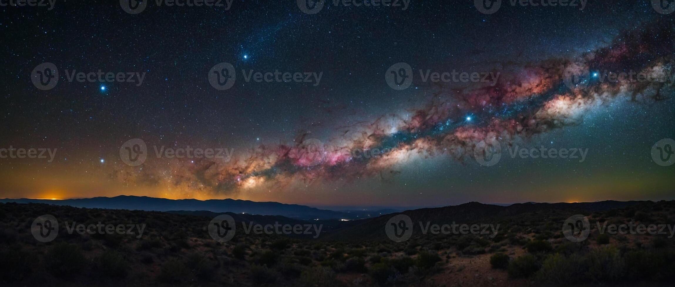 The milky way over the mountains in the night sky photo