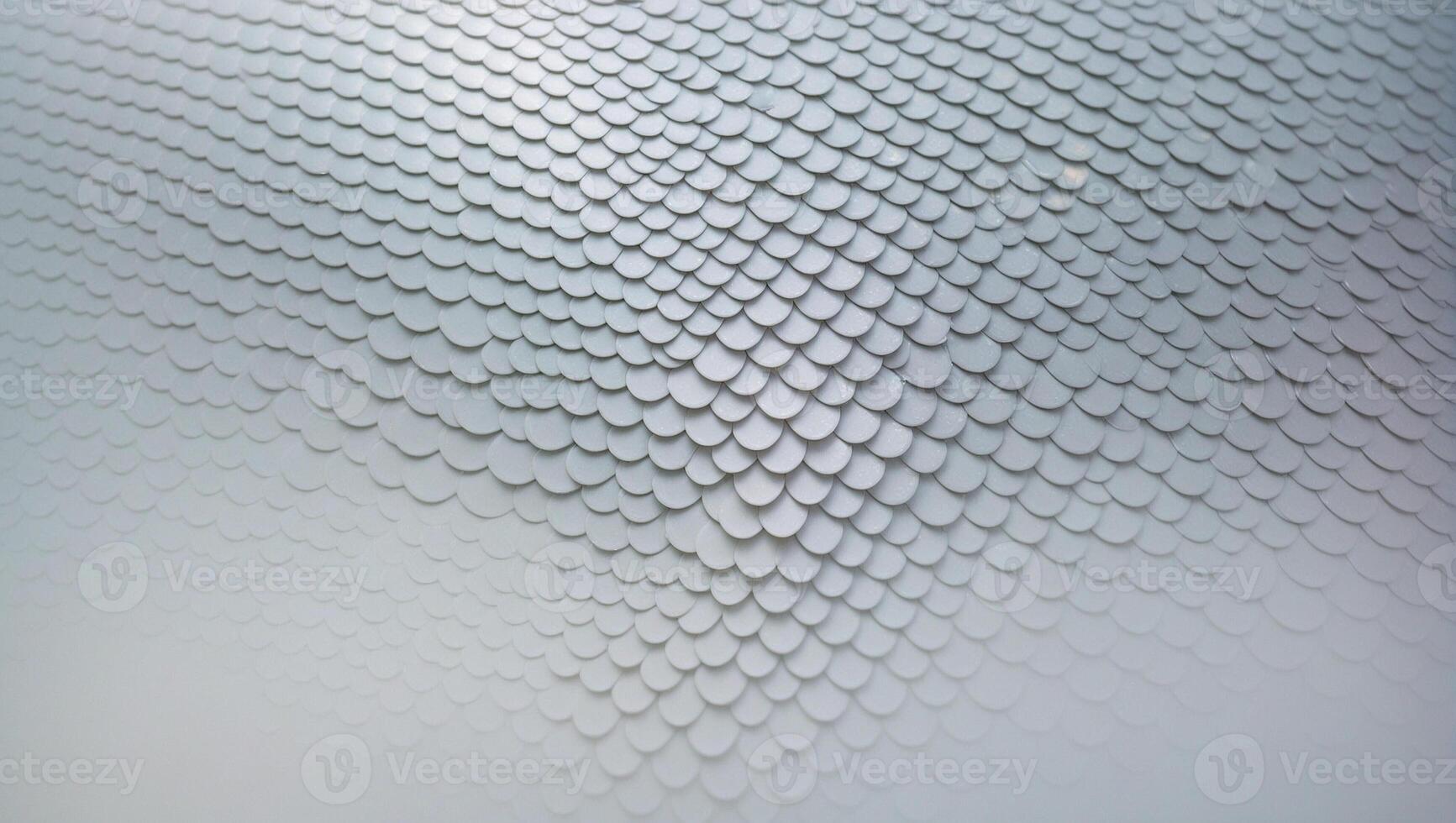 A close up of a white wall with a pattern of scales photo