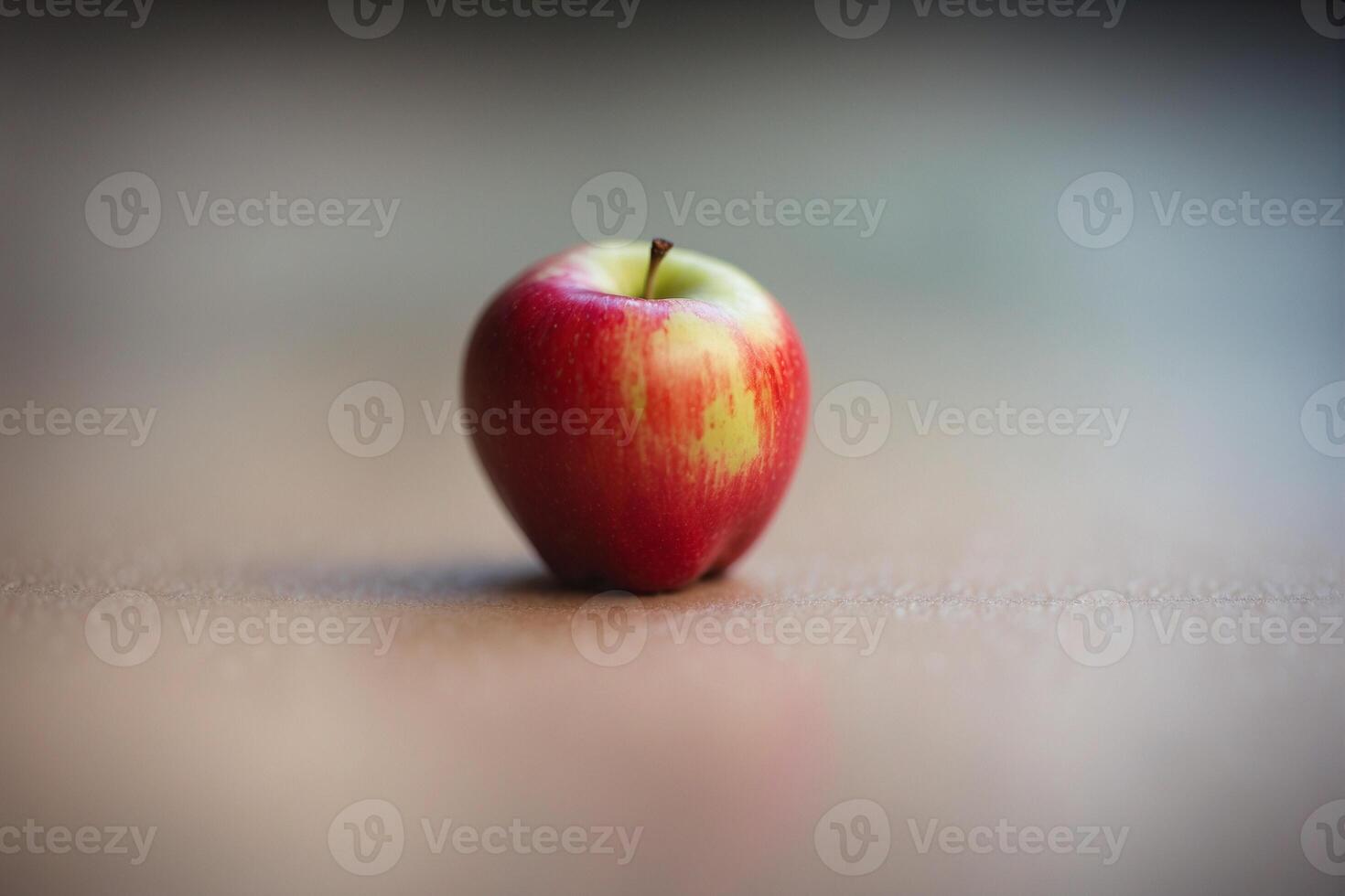 A single red apple on a table photo