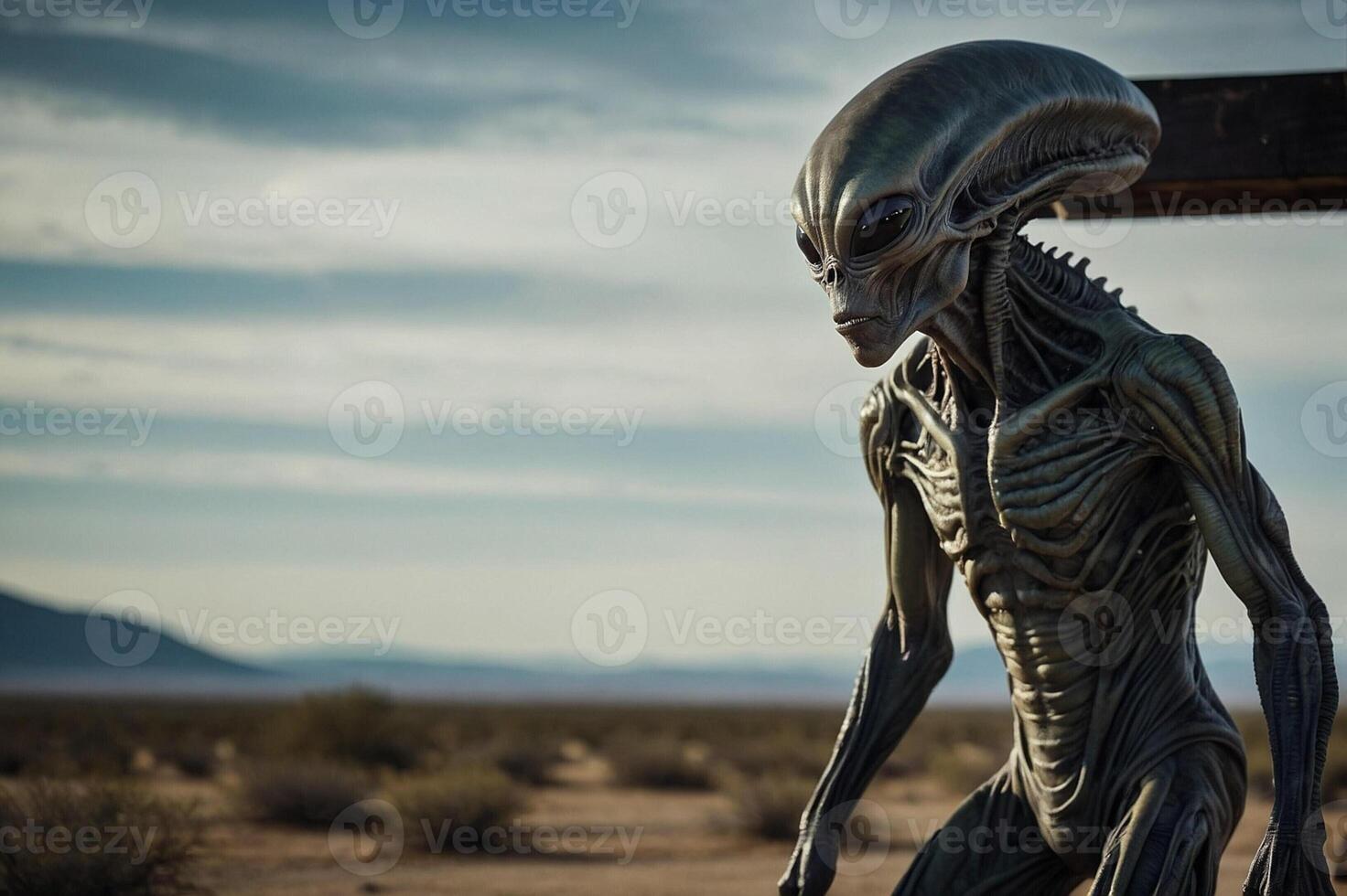 An alien statue stands in the desert photo