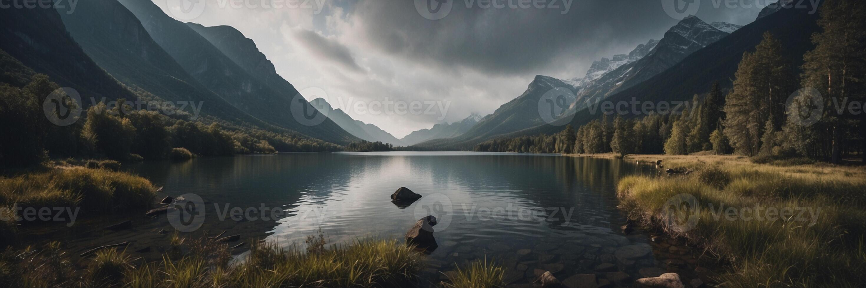 A lake surrounded by mountains and trees photo
