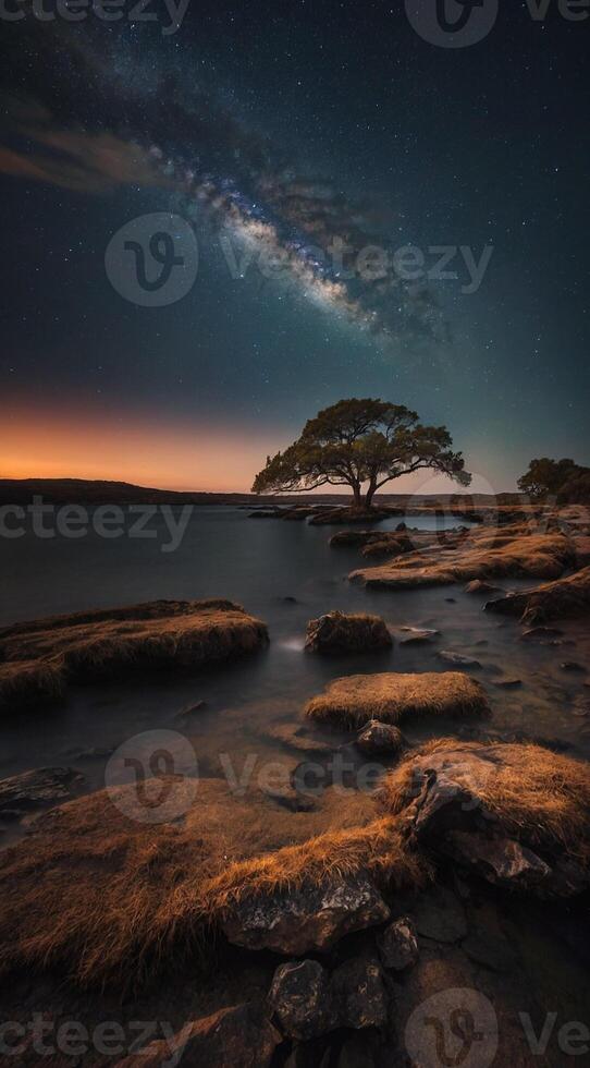 The milky way over the lake at night photo