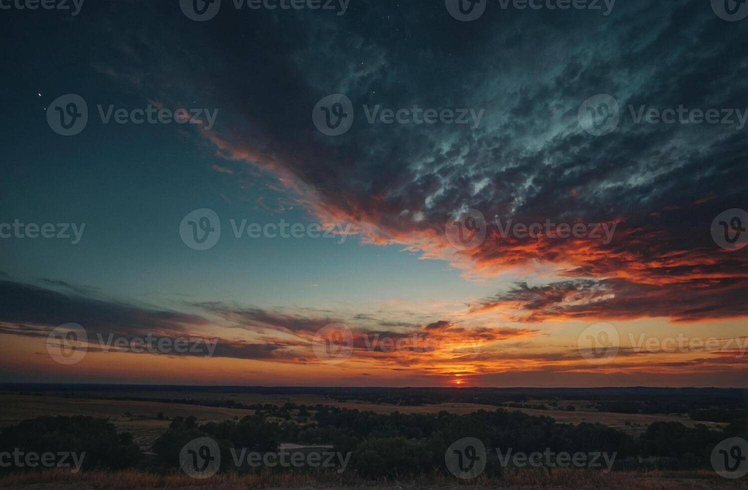 A sunset over a field with clouds and trees photo