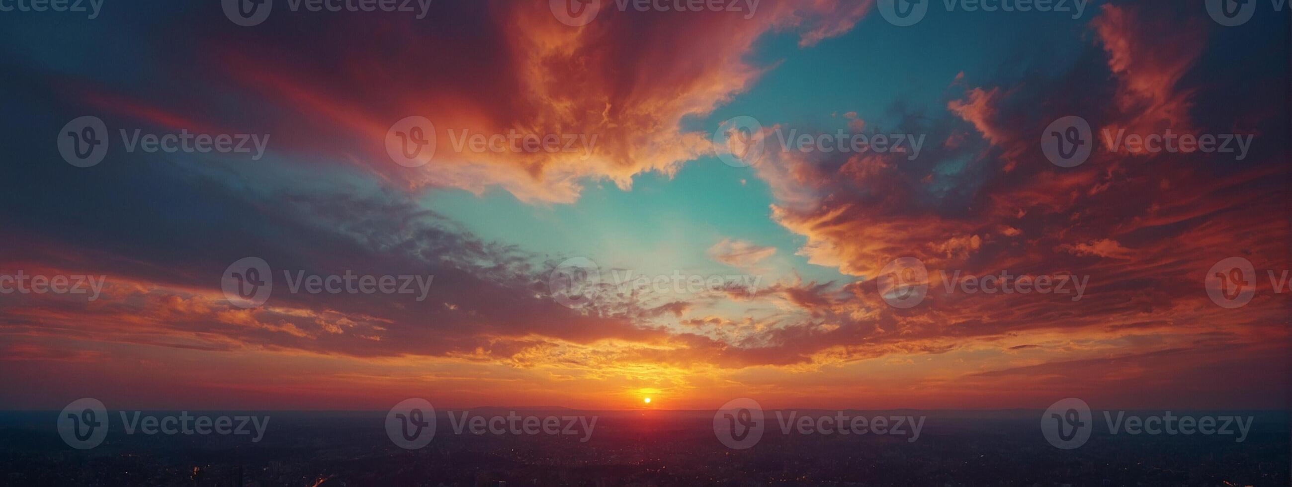 A sunset over a city with clouds in the sky photo