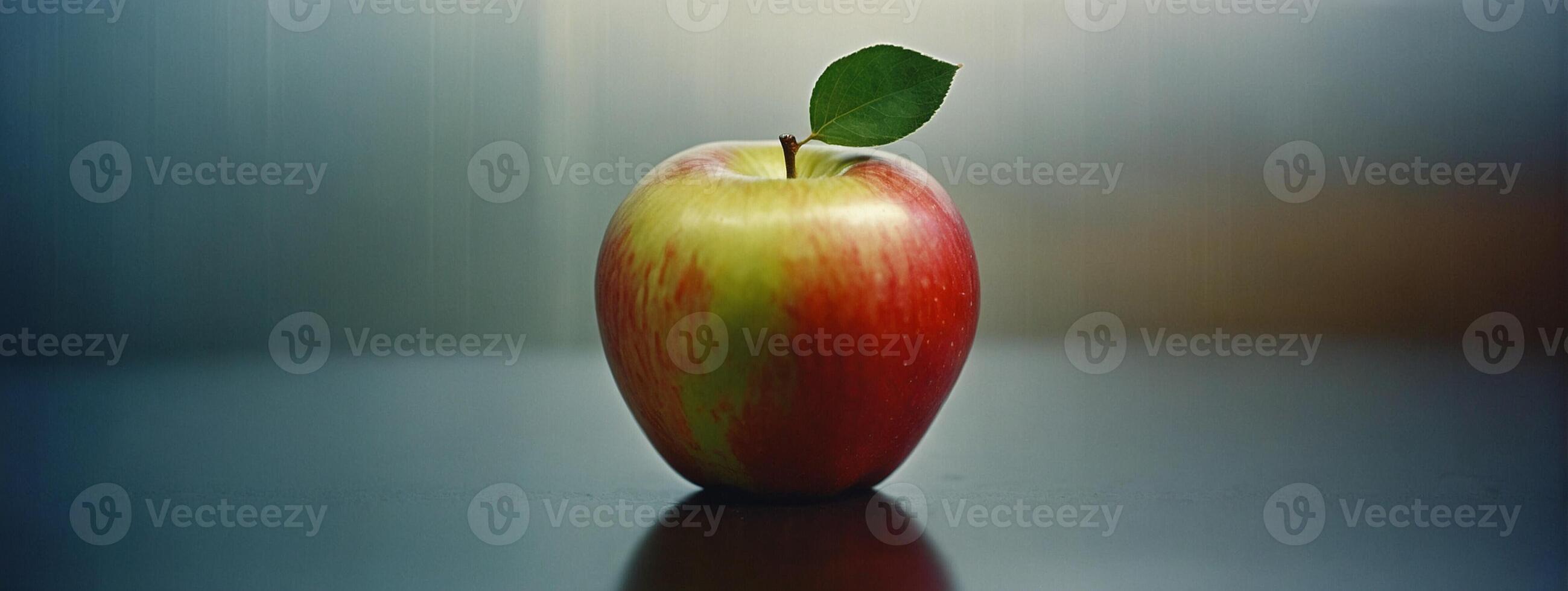 An apple is shown on a table with a blurred background photo