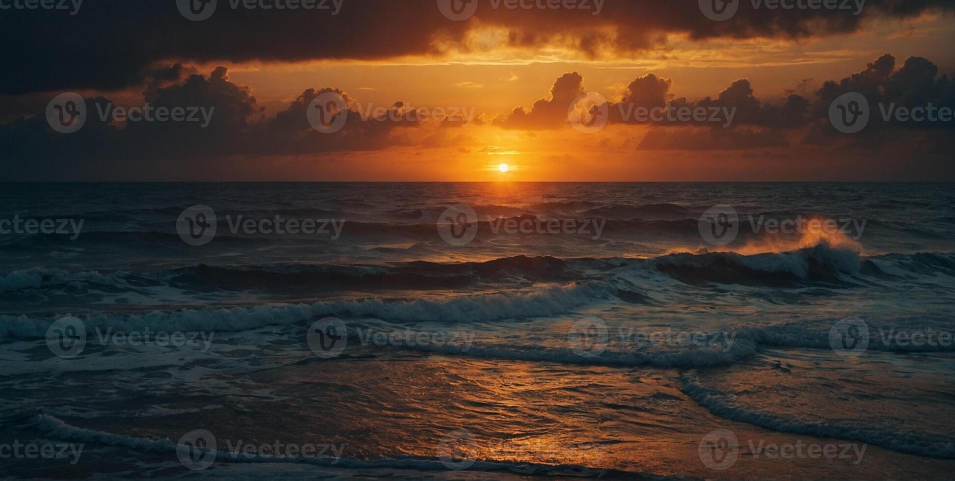 A sunset over the ocean with waves and clouds photo