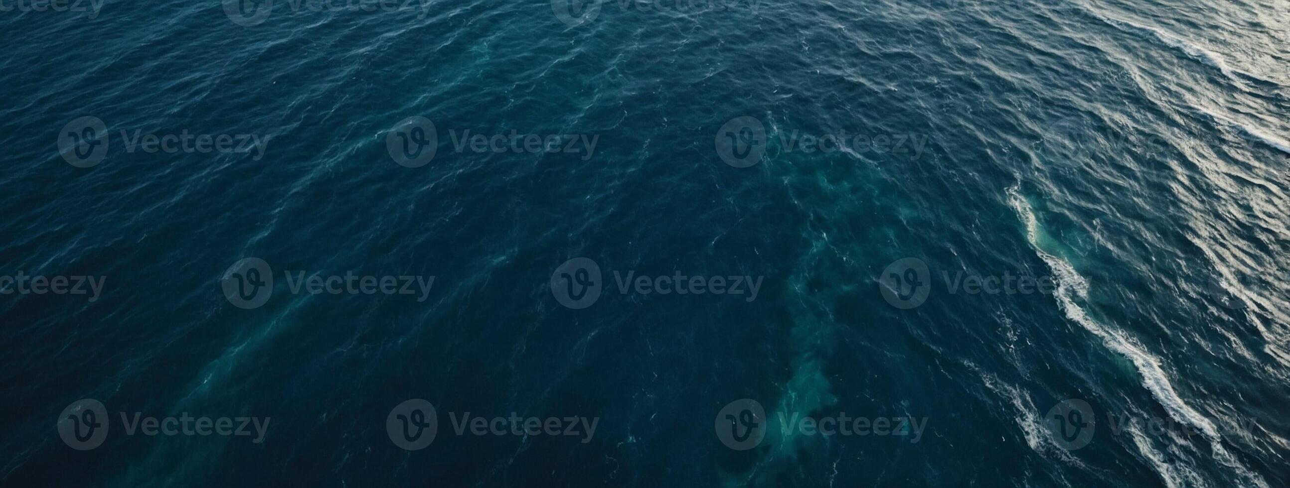 An aerial view of the ocean with waves photo