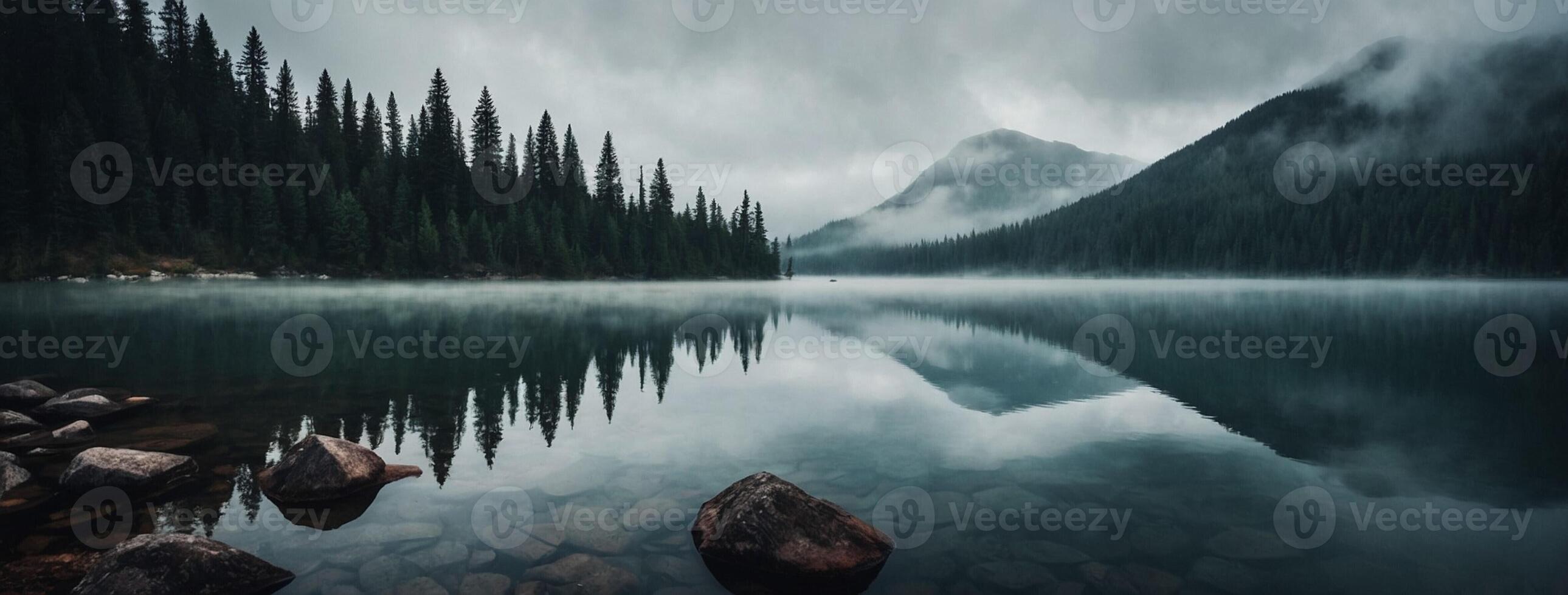 A lake surrounded by trees and mountains photo